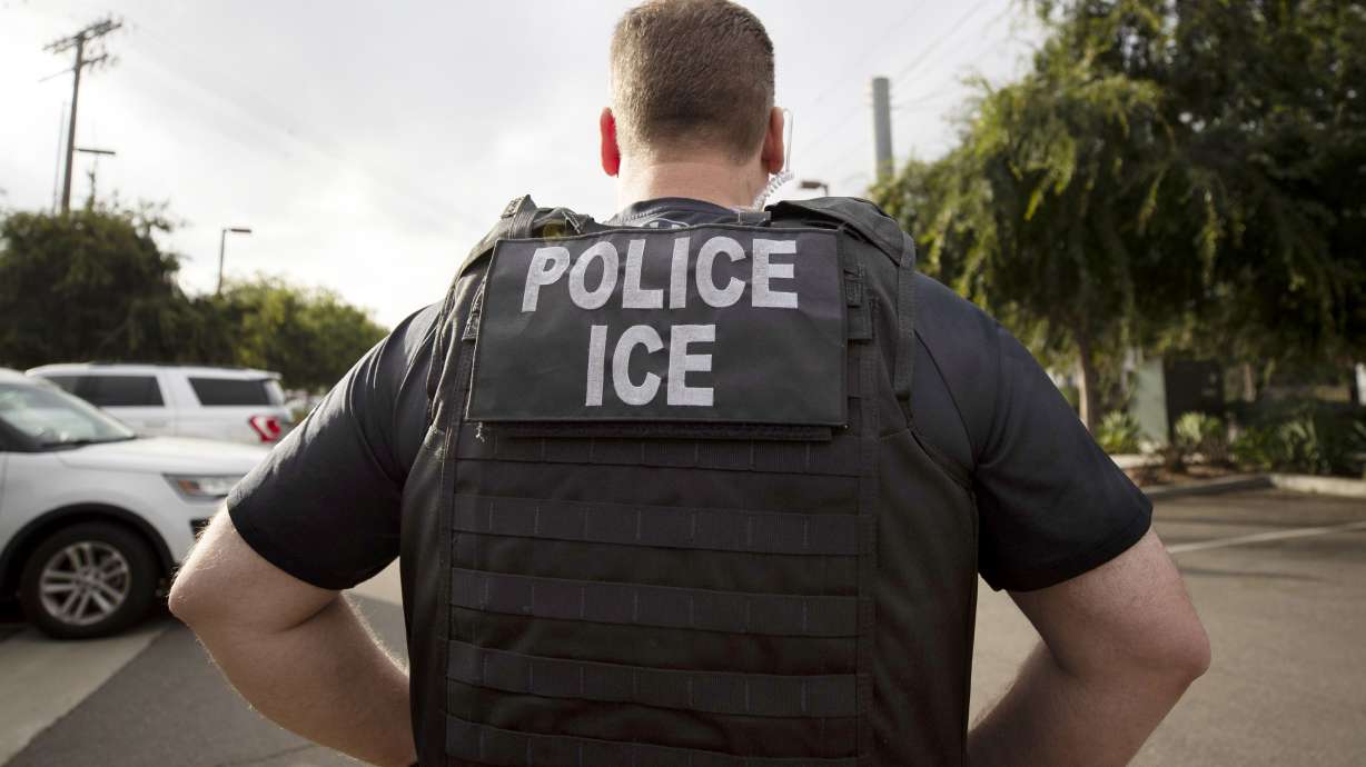 A U.S. Immigration and Customs Enforcement officer looks on during an operation in Escondido, Calif., July 8, 2019. The agency has what researchers call a "dragnet" surveillance system, compiling personal data and tracking the habits of 75% of Americans in attempt to deport undocumented people.