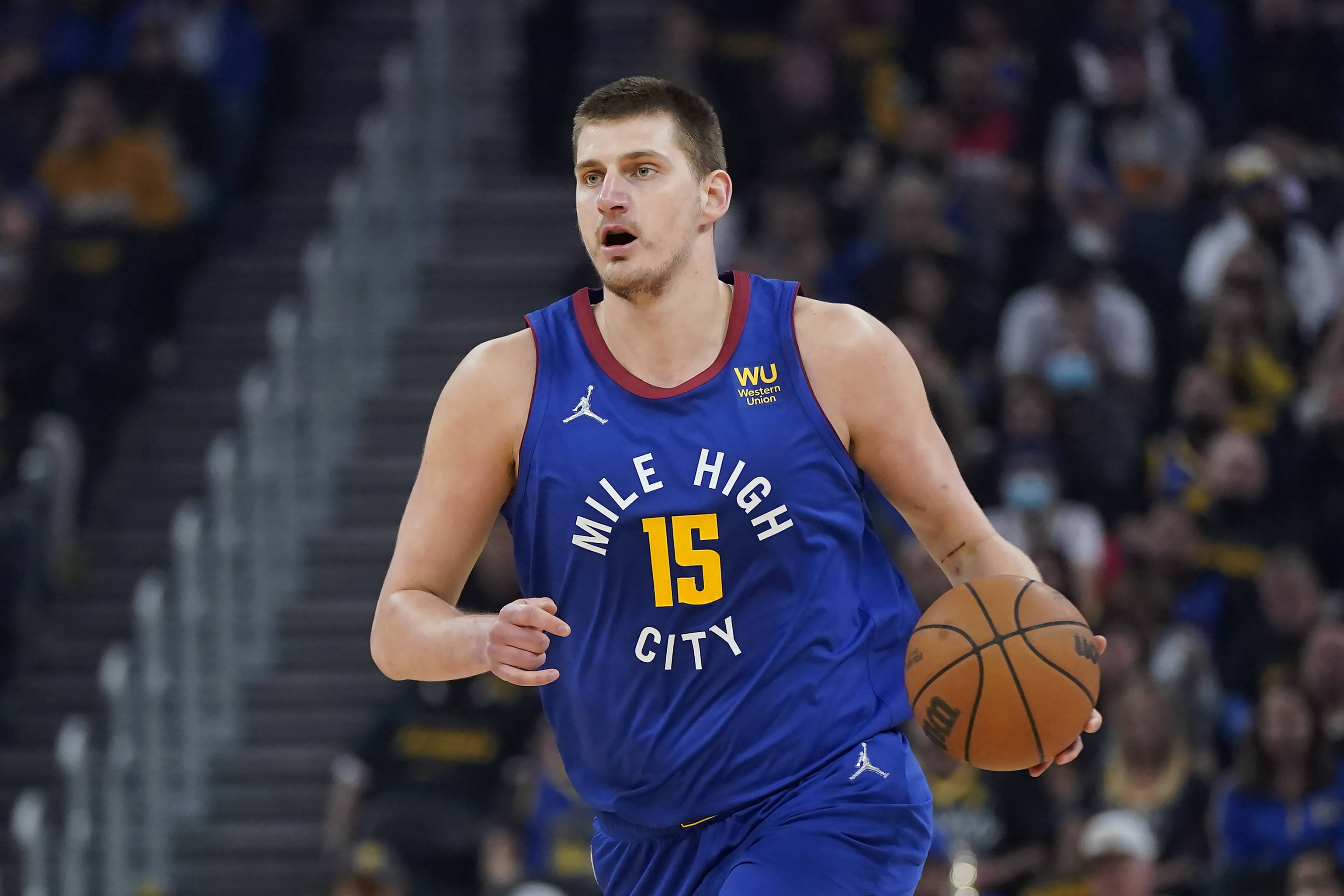 FILE - Denver Nuggets center Nikola Jokic (15) dribbles the ball up the court against the Golden State Warriors during the first half of Game 2 of an NBA basketball first-round playoff series in San Francisco, Monday, April 18, 2022. Jokic has won his second consecutive Most Valuable Player award after a season in which he finished with numbers never before seen in NBA history, a person familiar with the decision told The Associated Press on Monday, May 9, 2022. 