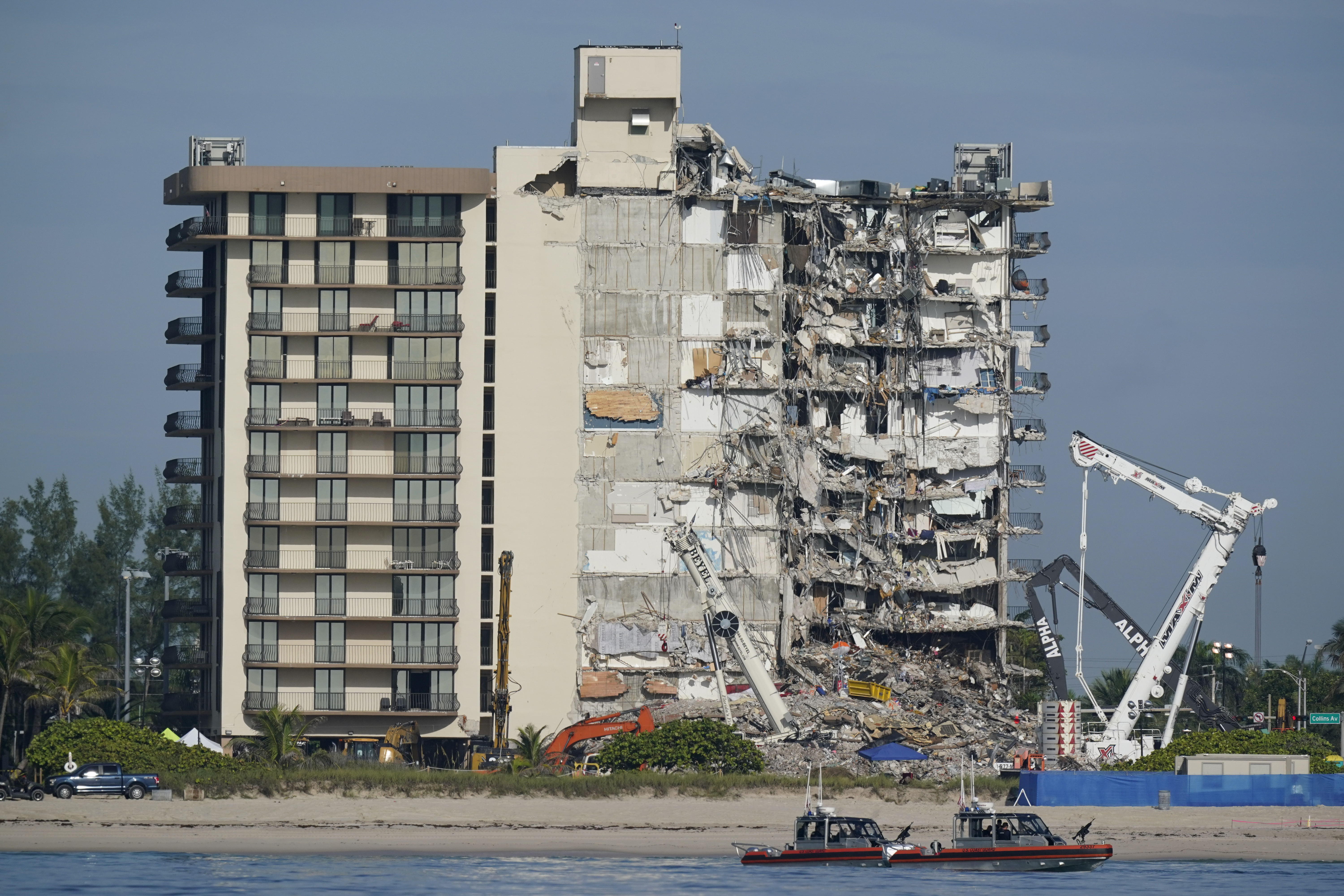 Coast Guard boats patrol in front of the partially collapsed Champlain Towers South condo building, July 1, 2021, in Surfside, Fla. A nearly $1 billion tentative settlement has been reached in a class-action lawsuit brought by families of victims and survivors, an attorney said Wednesday. 