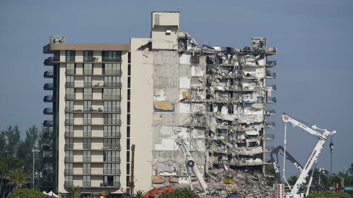 Coast Guard boats patrol in front of the partially collapsed Champlain Towers South condo building, July 1, 2021, in Surfside, Fla. A nearly $1 billion tentative settlement has been reached in a class-action lawsuit brought by families of victims and survivors, an attorney said Wednesday.