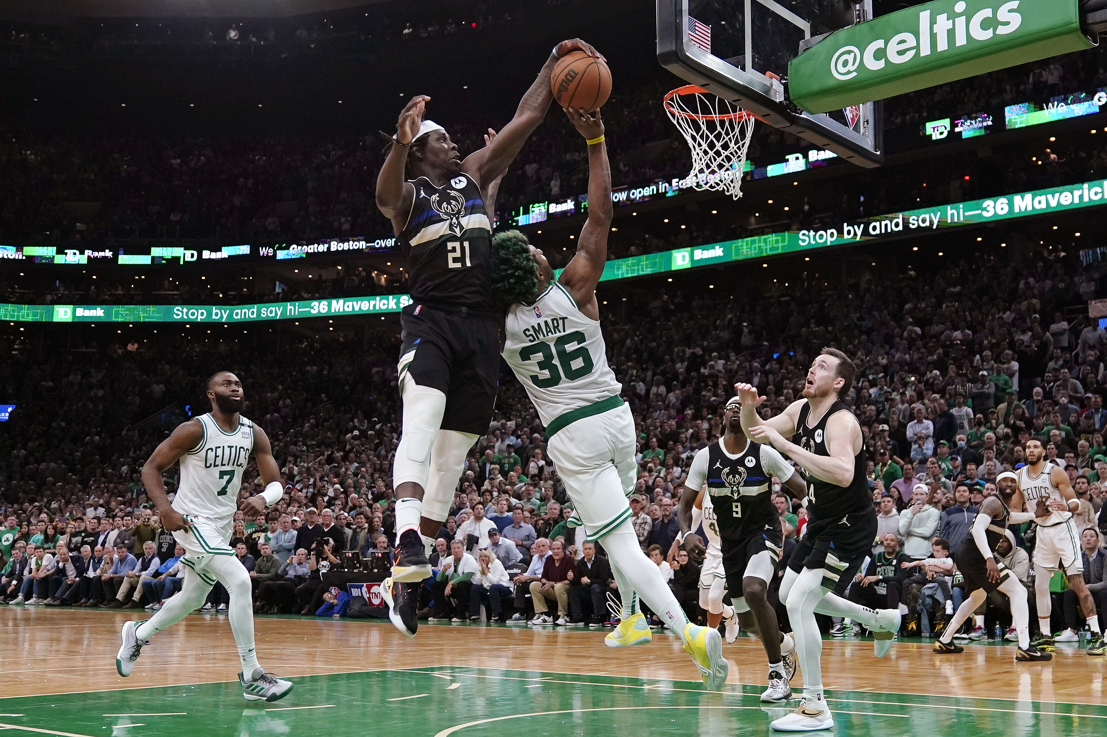 Milwaukee Bucks guard Jrue Holiday (21) blocks a shot by Boston Celtics guard Marcus Smart (36) in the final seconds of play during the second half of Game 5 of an Eastern Conference semifinal in the NBA basketball playoffs, Wednesday, May 11, 2022, in Boston. The Bucks won 110-107. 