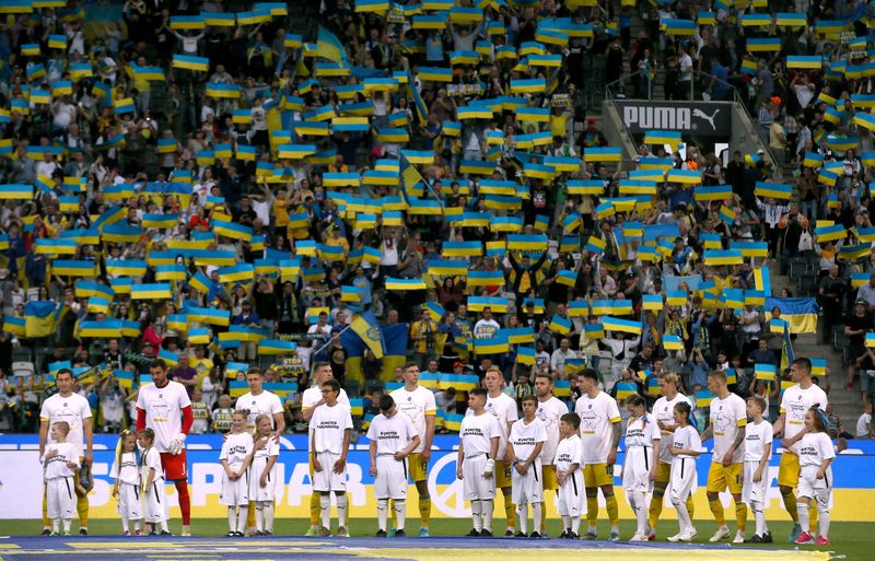 Soccer Football - Friendly - A match for peace and the end of war in Ukraine - Borussia Moenchengladbach v Ukraine - Borussia-Park, Moenchengladbach, Germany - May 11, 2022 Ukraine players line up with young mascots before the match