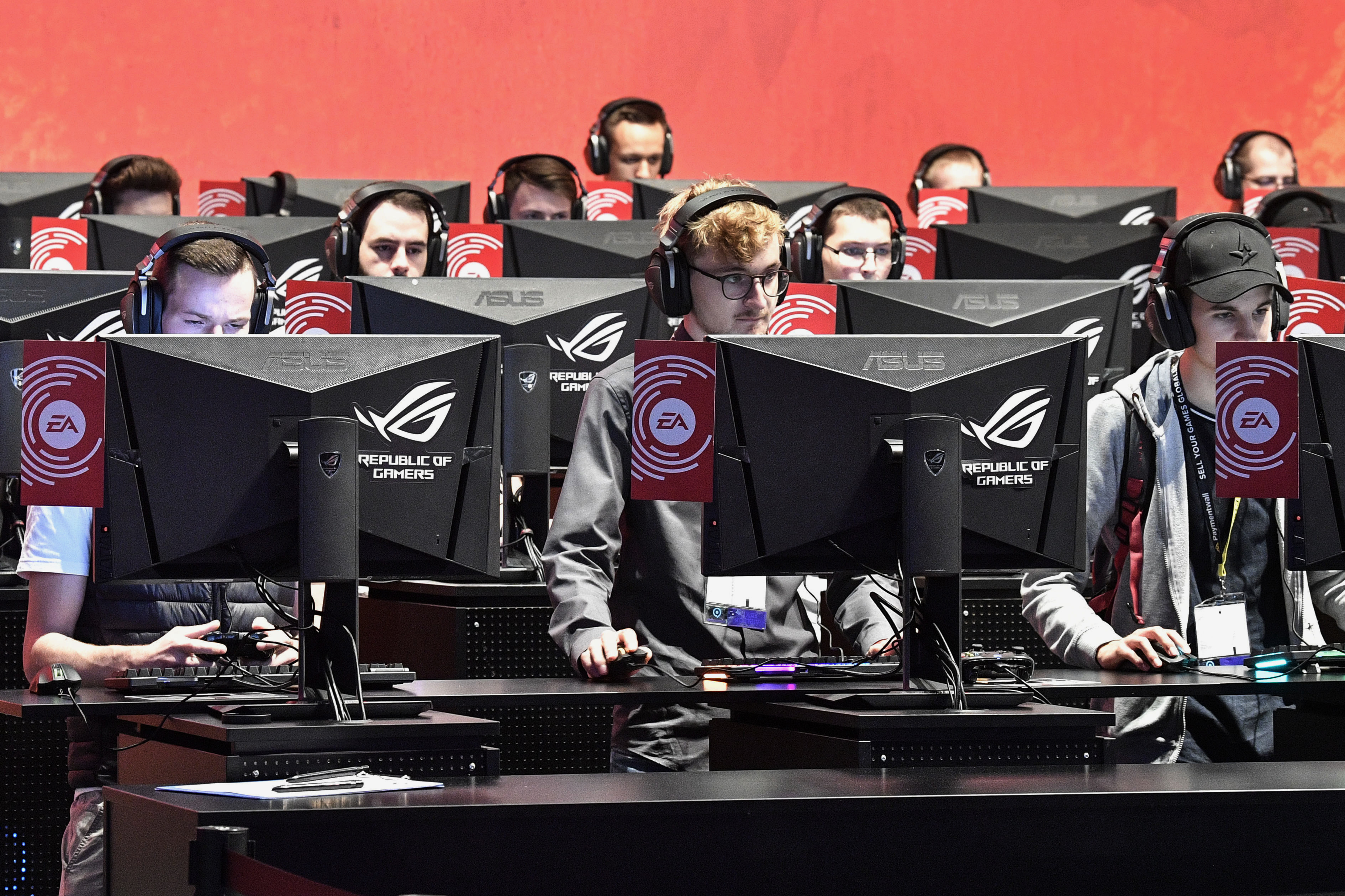 FILE - In this Aug. 20, 2019 file photo, gamers play latest video games from Electronic Arts at the Gamescom in Cologne, Germany. For three decades, the Zurich-based organizers of soccer have enjoyed a flourishing, mutually beneficial relationship with EA Sports producing annual edition of the FIFA game, alongside related products, and raking in billions of dollars. It so lucrative that FIFA thinks, it can be making even more cash. Now they are becoming opponents. 