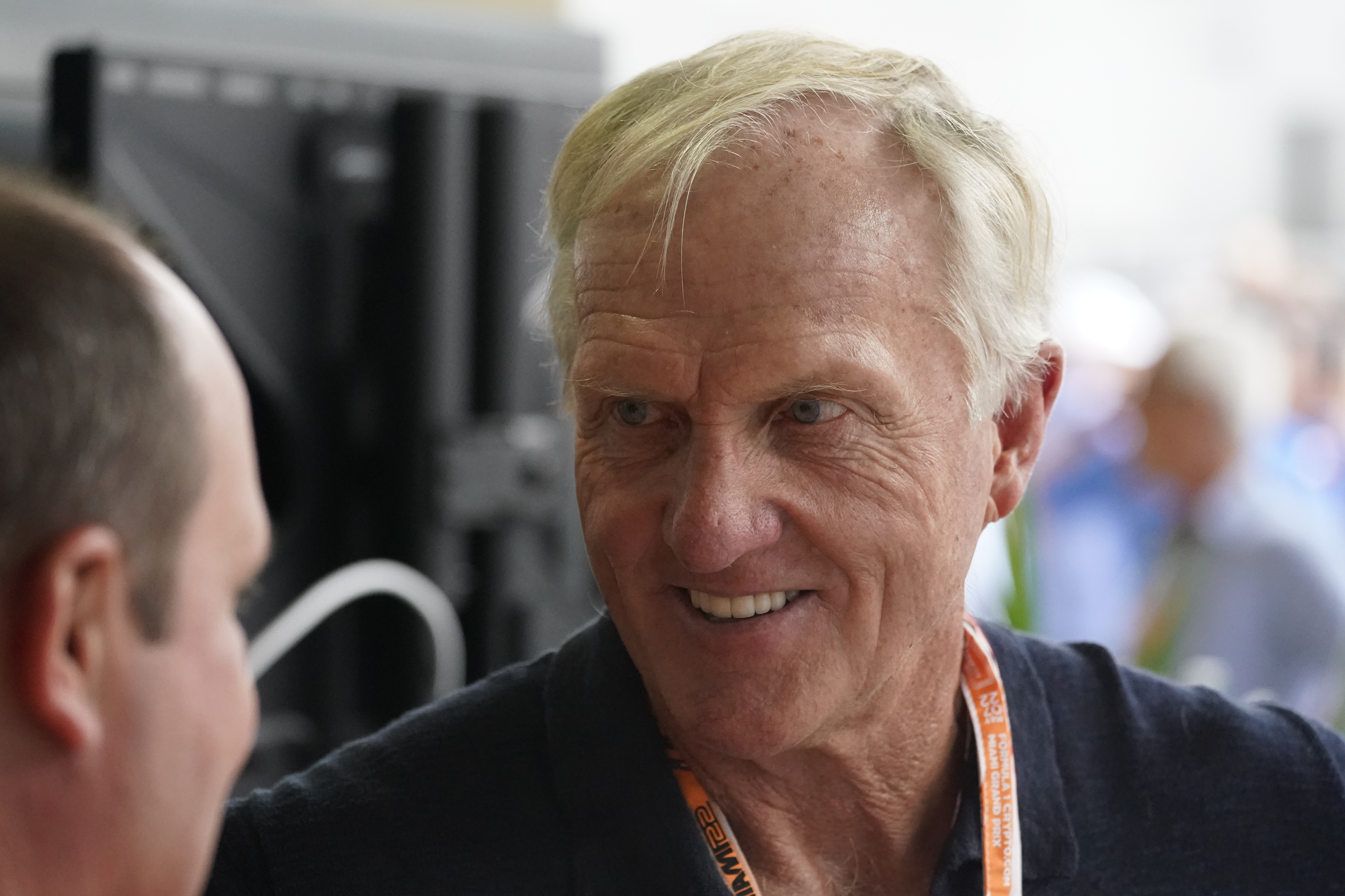 Professional golfer Greg Norman walks through the pit area during the third practice session for the Formula One Miami Grand Prix auto race at the Miami International Autodrome, Saturday, May 7, 2022, in Miami Gardens, Fla. 