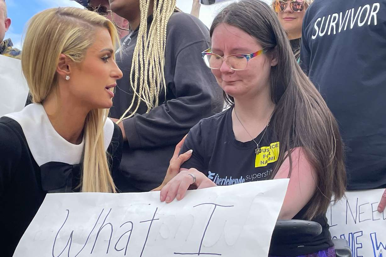 Paris Hilton, left, talks to Sasha Oates, right, from Sacramento, Calif., after speaking at a Stop Institutional Child Abuse event on Wednesday, in Washington. Hilton is in Washington advocating efforts to improve protection of youth in residential programs and facilities.