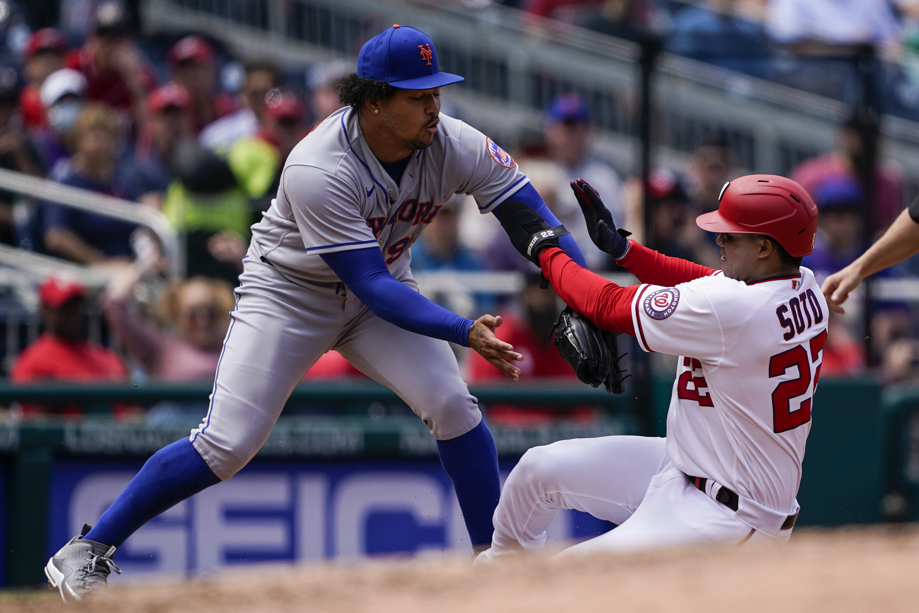 New York Mets third baseman Luis Guillorme, left, makes the tag on Washington Nationals' Juan Soto on the fielder's choice during the fourth inning of a baseball game at Nationals Park, Thursday, May 12, 2022, in Washington. 