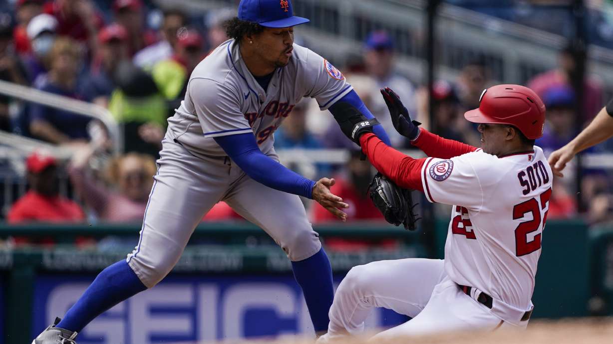 New York Mets third baseman Luis Guillorme, left, makes the tag on Washington Nationals' Juan Soto on the fielder's choice during the fourth inning of a baseball game at Nationals Park, Thursday, May 12, 2022, in Washington.