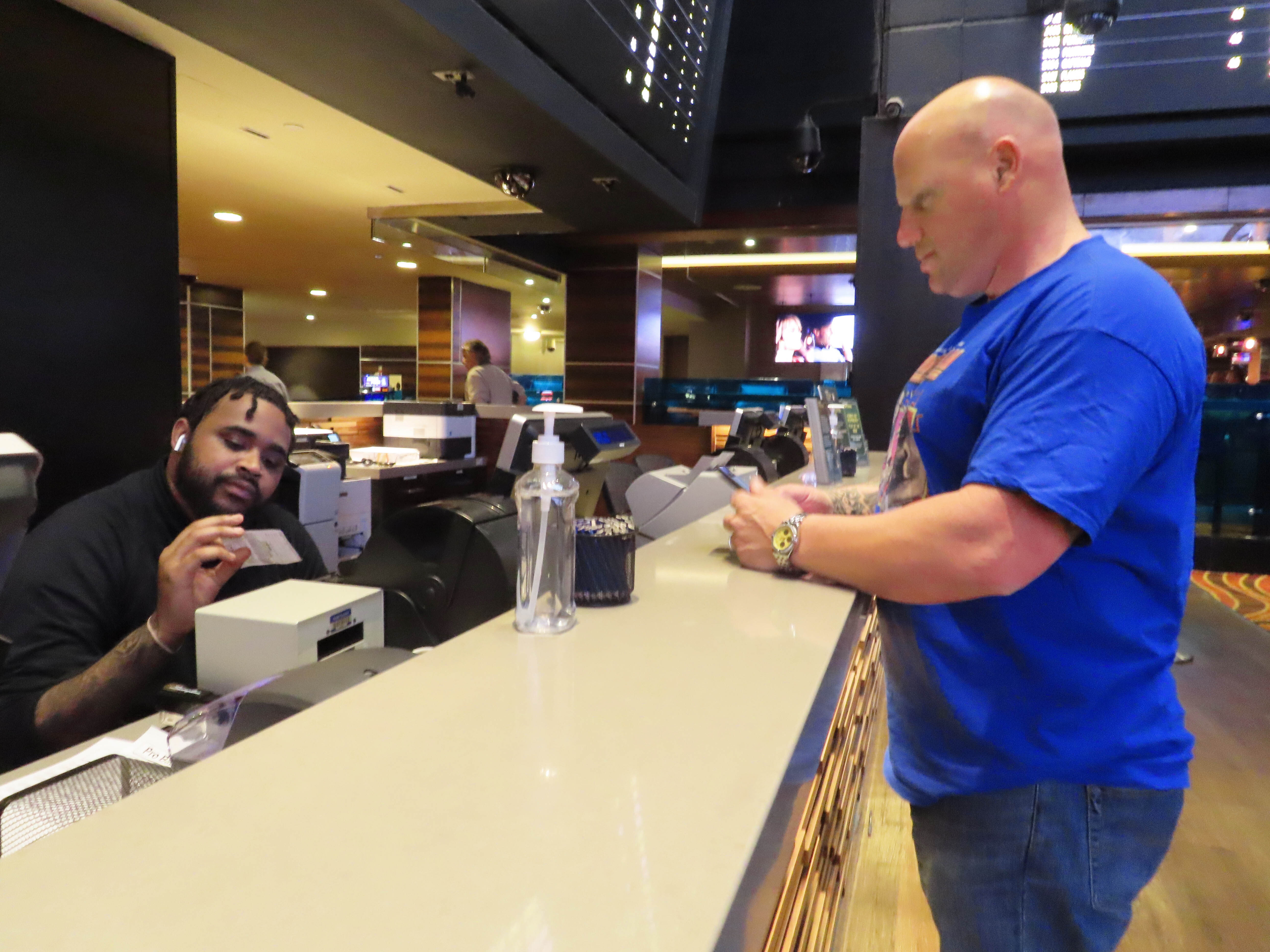 A customer cashes a winning ticket on a New York Mets baseball game in the sports betting lounge at the Tropicana casino in Atlantic City N.J. on Thursday, May 12, 2022. American gamblers have wagered over $125 billion on sports with legal betting outlets in the four years since the U.S. Supreme Court cleared the way for all 50 states to offer legal sports betting; about two thirds currently do. 