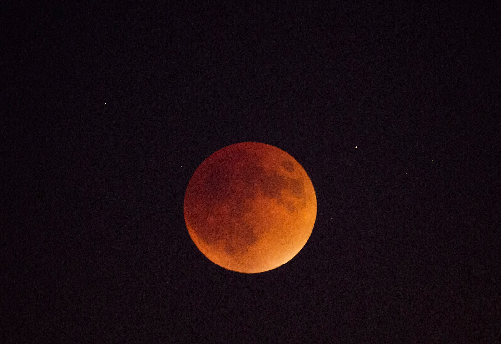 May's moon will glow a scarlet color during this year's first total lunar eclipse on Sunday, a stark contrast to its ordinarily milky white sheen.