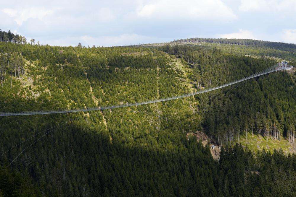 Visitors cross a suspension bridge for the pedestrians that is the longest bridge of its type in the world, in Dolni Morava, Czech Republic, Friday.