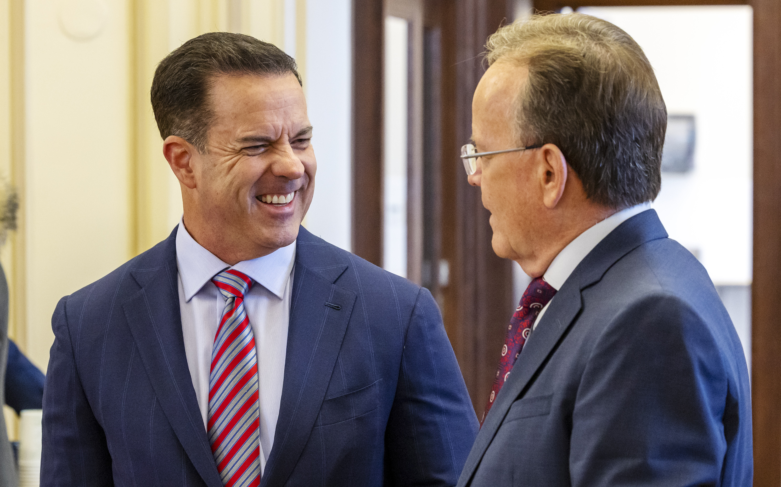House Speaker Brad Wilson, R-Kaysville, left, and Senate President Stuart Adams, R-Layton, talk prior to a panel discussion on the 2022 legislative session in Salt Lake City on March 8. Wilson tested positive for COVID-19 late Thursday, his office confirmed.