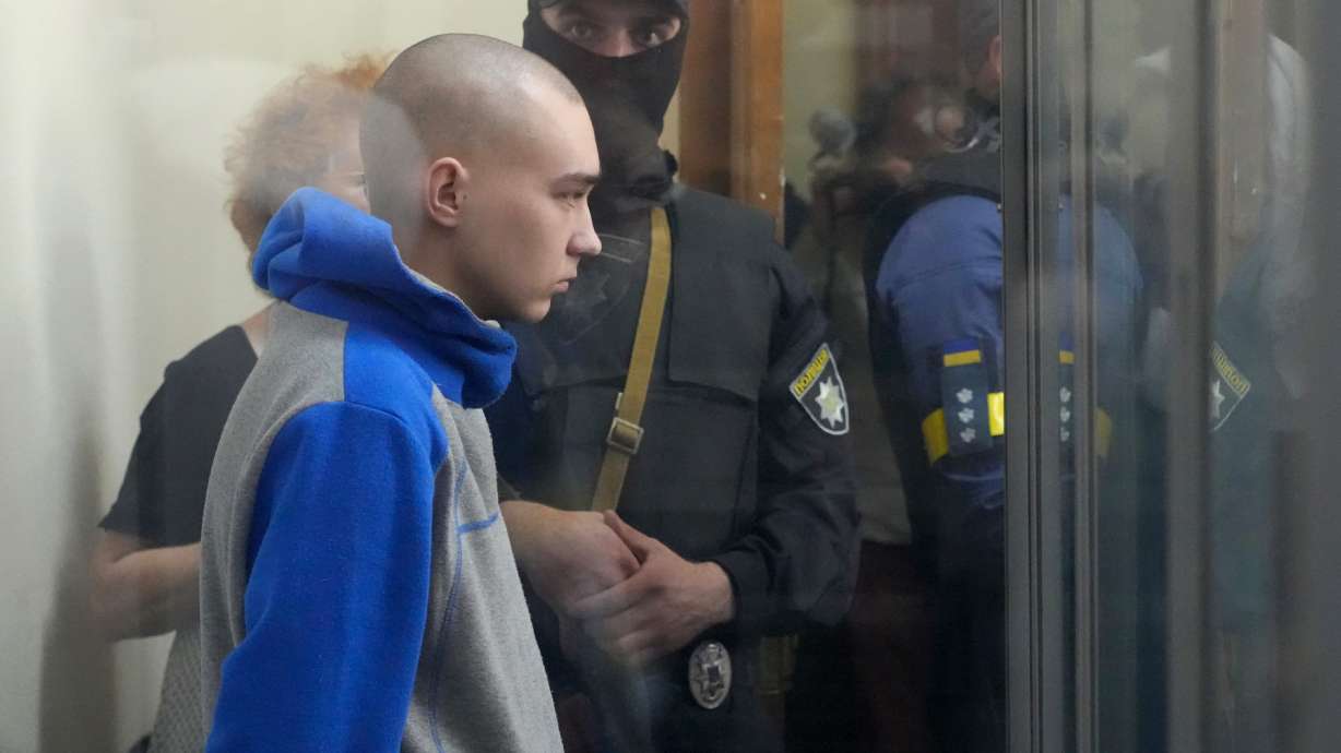 Russian army Sergeant Vadim Shishimarin, 21, is seen behind a glass during a court hearing in Kyiv, Ukraine, Friday. The trial of a Russian soldier accused of killing a Ukrainian civilian opened Friday, the first war crimes trial since Moscow's invasion of its neighbor.