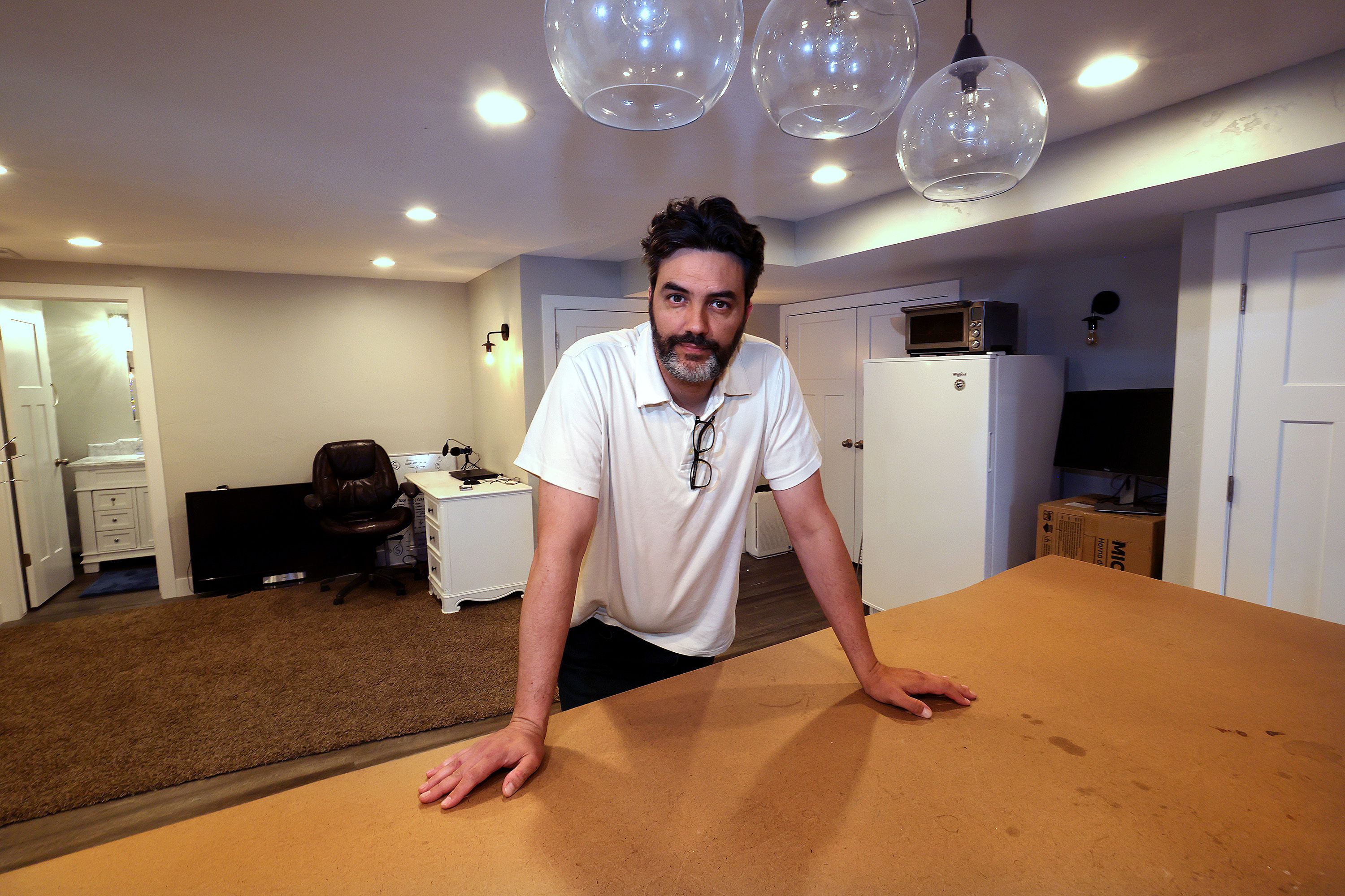 Herriman resident Michael Atkinson poses for a photo as he shows his basement apartment on Friday, May 13, 2022. The apartment will soon house a Ukrainian refugee family.