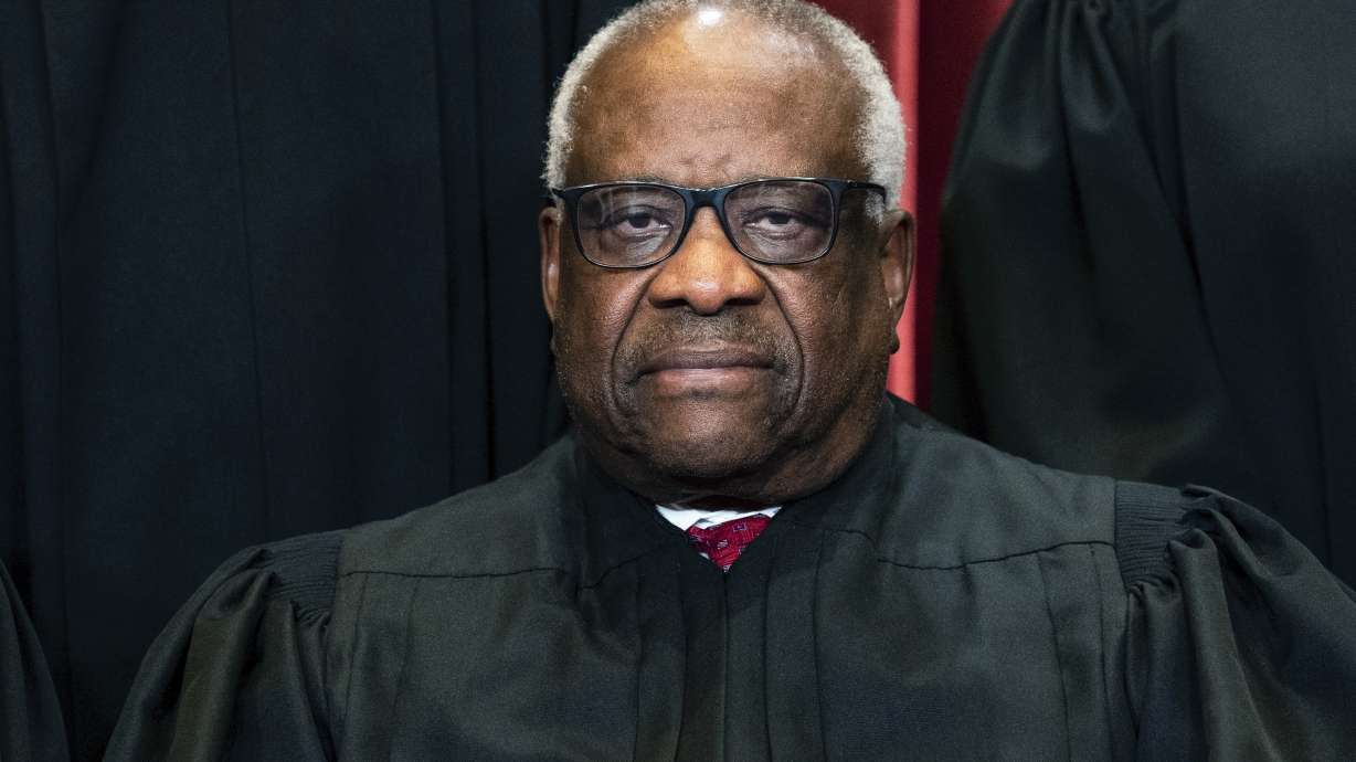 Justice Clarence Thomas sits during a group photo at the Supreme Court in Washington, on April 23, 2021. Thomas says the Supreme Court has been changed by the shocking leak of a draft opinion earlier this month.