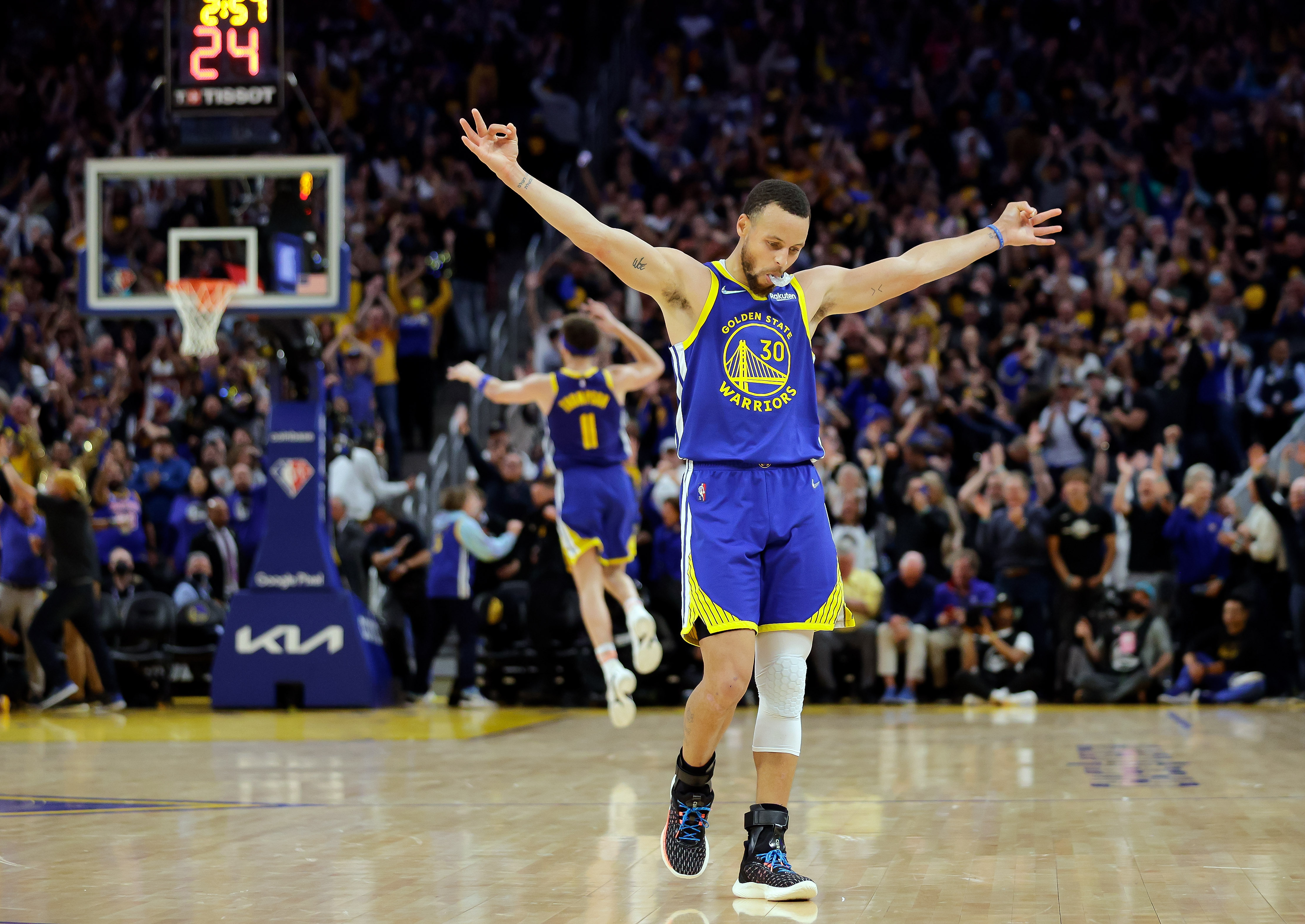 Golden State Warriors' Stephen Curry (30) celebrates a 3-pointer by Klay Thompson's against the Memphis Grizzles during the second half in Game 6 of the Western Conference semifinals of the NBA basketball playoffs in San Francisco on Friday, May 13, 2022. The Warriors defeated the Grizzlies 110-96 to advance to the conference finals. 