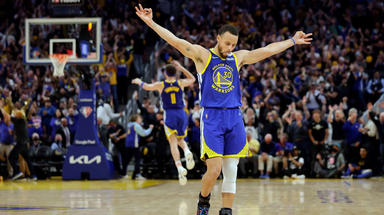 Golden State Warriors' Stephen Curry (30) celebrates a 3-pointer by Klay Thompson's against the Memphis Grizzles during the second half in Game 6 of the Western Conference semifinals of the NBA basketball playoffs in San Francisco on Friday, May 13, 2022. The Warriors defeated the Grizzlies 110-96 to advance to the conference finals.