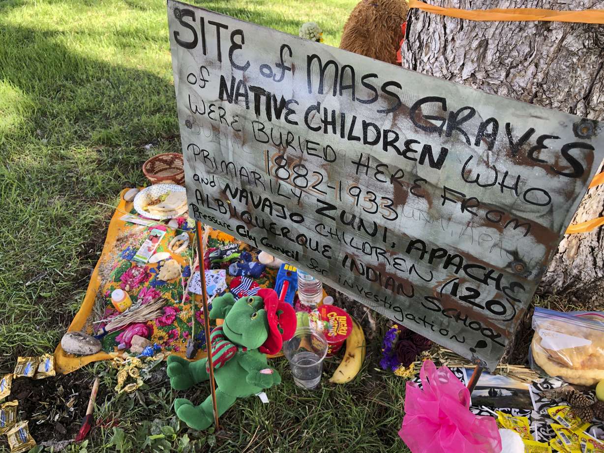 In this July 1, 2021 photo a makeshift memorial for the dozens of Indigenous children who died more than a century ago while attending a boarding school that was once located nearby is growing under a tree at a public park in Albuquerque, N.M. The Department of the Interior report, released Wednesday, May 11, 2022, says the federal government provided funding and other support to religious boarding schools for Native children in the 19th and early 20th centuries to an extent that normally would have been prohibited by bans on the use of federal funds for religious schools.