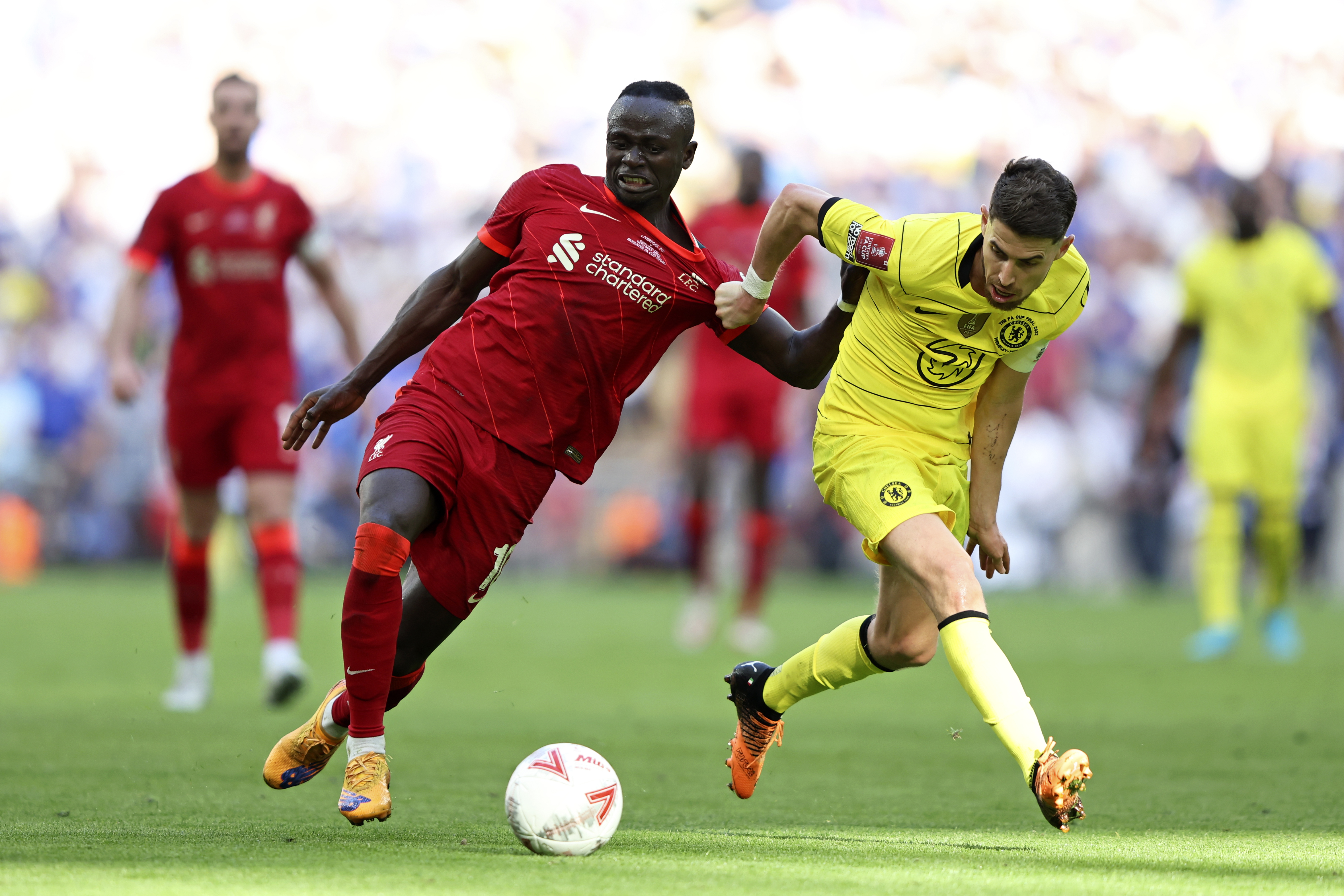 Chelsea's Jorginho, right, fights for the ball with Liverpool's Sadio Mane during the English FA Cup final soccer match between Chelsea and Liverpool, at Wembley stadium, in London, Saturday, May 14, 2022. 