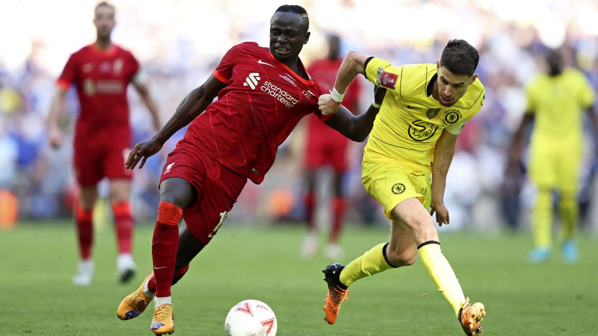 Chelsea's Jorginho, right, fights for the ball with Liverpool's Sadio Mane during the English FA Cup final soccer match between Chelsea and Liverpool, at Wembley stadium, in London, Saturday, May 14, 2022.
