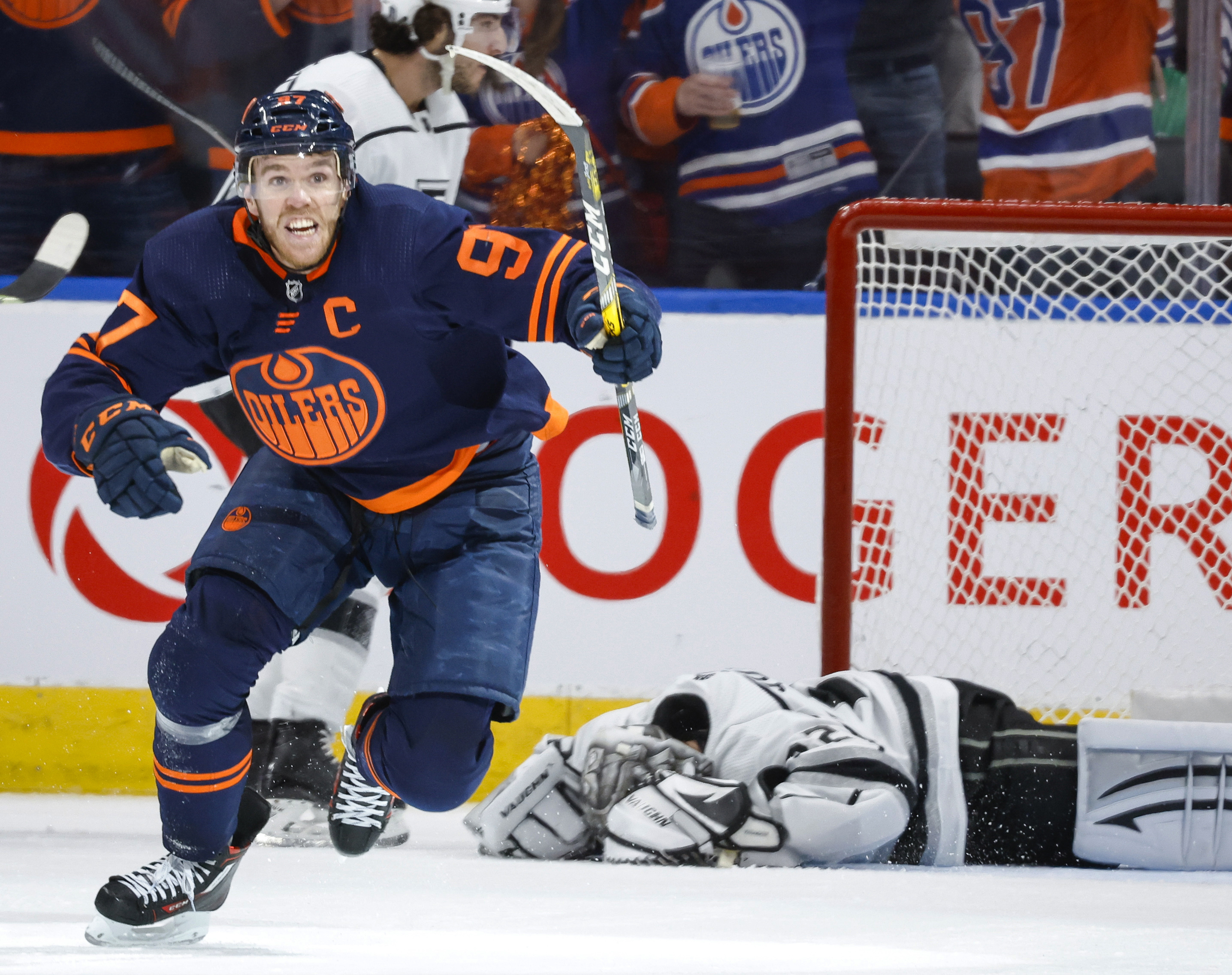 Los Angeles Kings goalie Jonathan Quick, right, lies on the ice as Edmonton Oilers center Connor McDavid celebrates his goal during the third period in Game 7 of a first-round series in the NHL hockey Stanley Cup playoffs Saturday, May 14, 2022, in Edmonton, Alberta. 