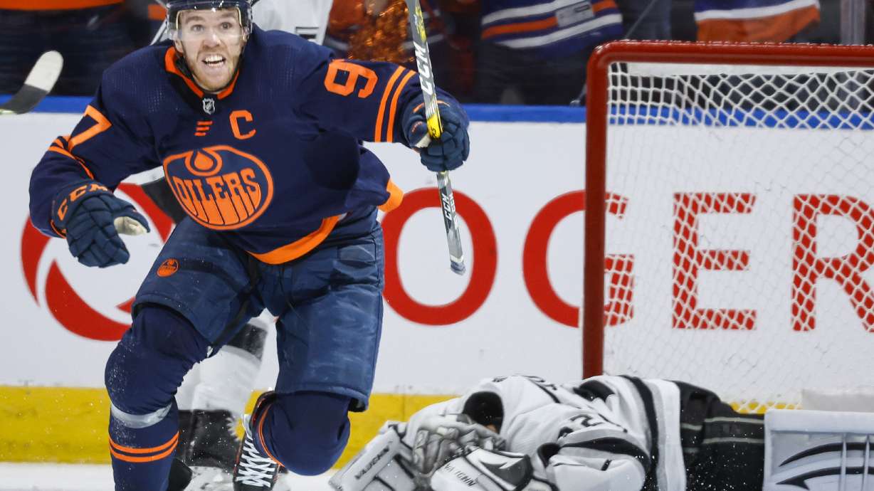 Los Angeles Kings goalie Jonathan Quick, right, lies on the ice as Edmonton Oilers center Connor McDavid celebrates his goal during the third period in Game 7 of a first-round series in the NHL hockey Stanley Cup playoffs Saturday, May 14, 2022, in Edmonton, Alberta.