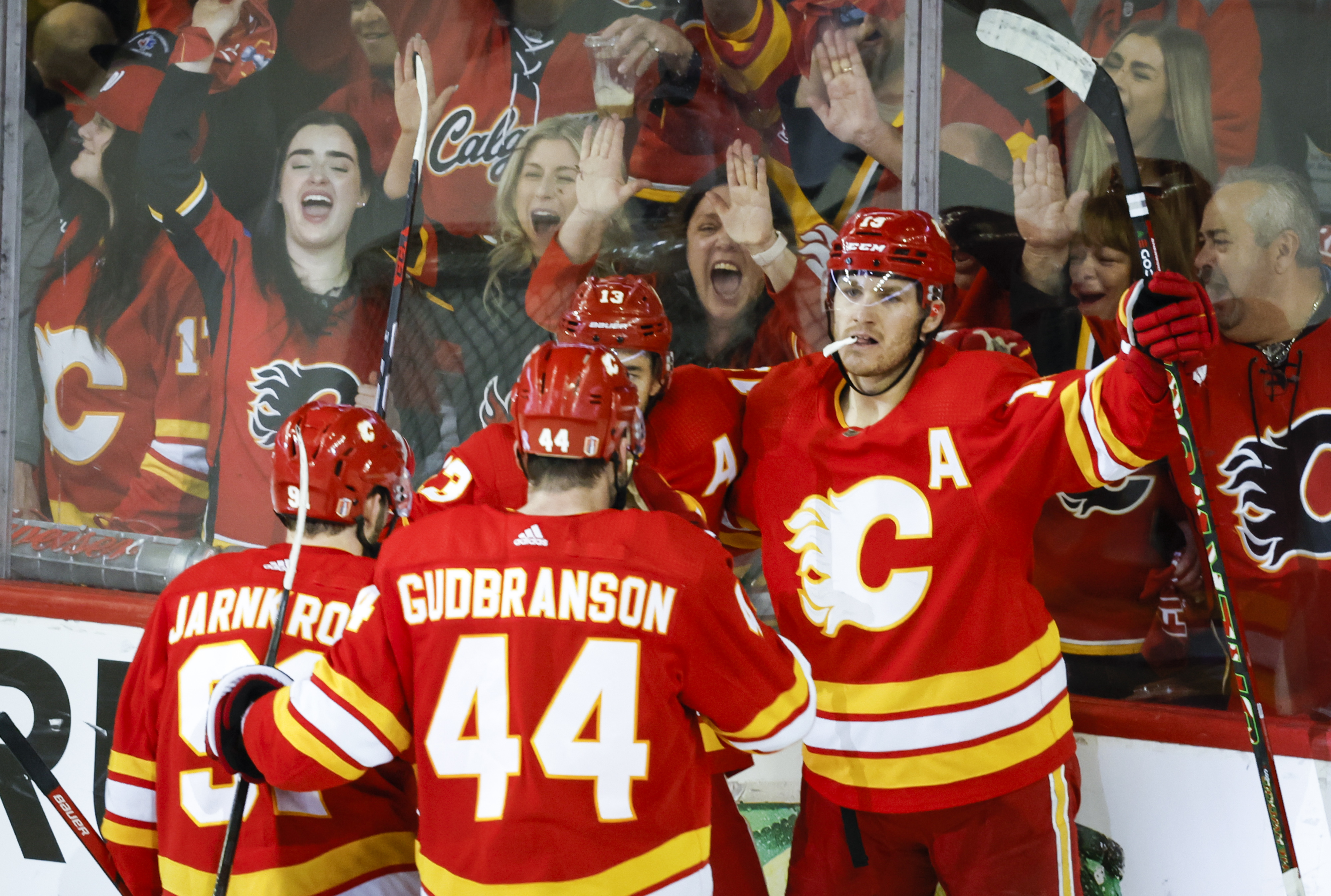 Calgary Flames forward Matthew Tkachuk, right, celebrates his goal with teammates during second period NHL playoff hockey action against the Dallas Stars in Calgary, Alberta, Sunday, May 15, 2022. 