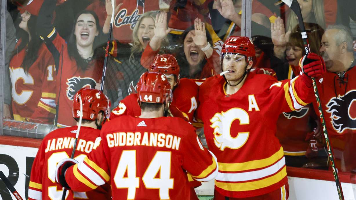 Calgary Flames forward Matthew Tkachuk, right, celebrates his goal with teammates during second period NHL playoff hockey action against the Dallas Stars in Calgary, Alberta, Sunday, May 15, 2022.