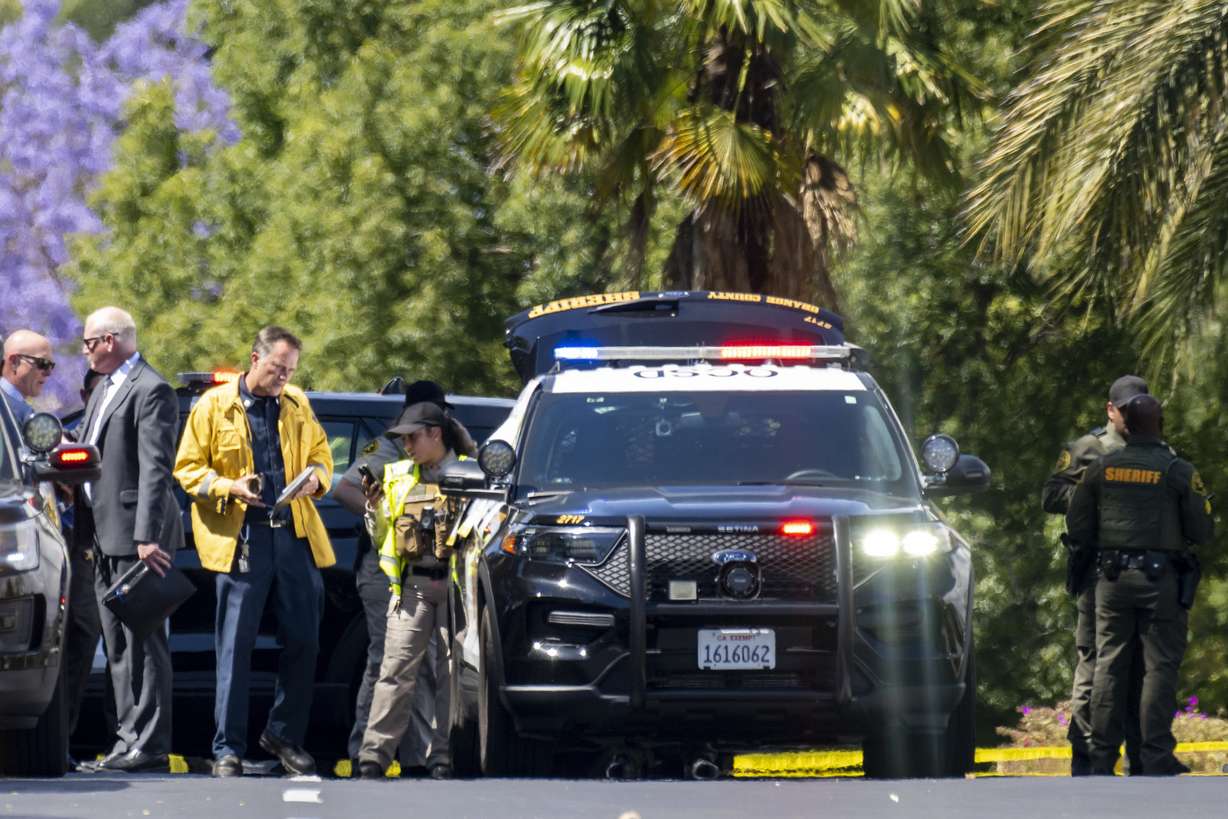 Investigators gather outside the Geneva Presbyterian Church in Laguna Woods, Calif., on Sunday after a fatal shooting.