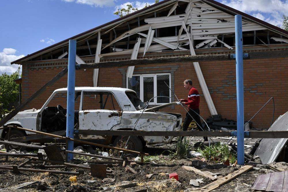 Alexander walks around his house destroyed by Russian shelling in Toretsk, Donetsk region, Ukraine, Monday. Europe is pushing to toughen its response to Moscow's invasion of Ukraine. Ukrainian troops repulsed Russia's attempted advances and even rolled back the front lines in places.