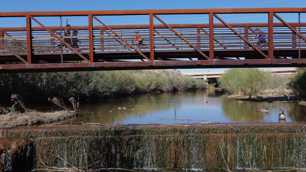 Pedestrians and bikers cross a bridge on the Virgin River Trail in St. George on April 9, 2021. In total, 12 environmental remediation projects in Utah will receive around $3.4 million in fiscal year 2022.