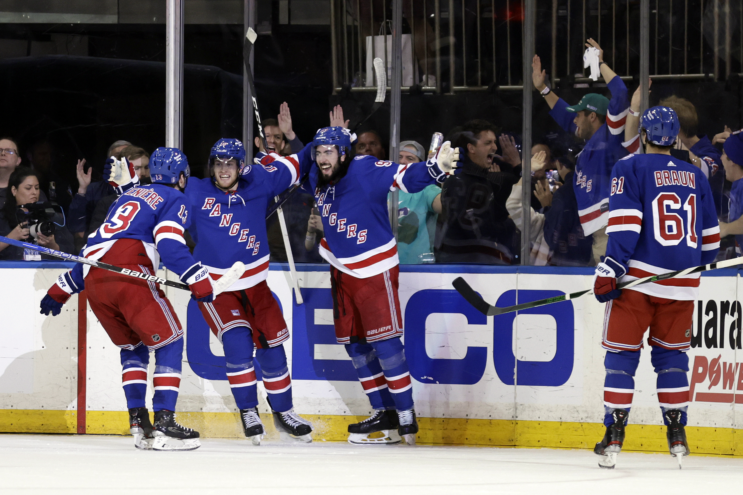 New York Rangers center Mika Zibanejad (93) celebrates with teammates after scoring a goal against the Pittsburgh Penguins during the third period in Game 7 of an NHL hockey Stanley Cup first-round playoff series Sunday, May 15, 2022, in New York. 