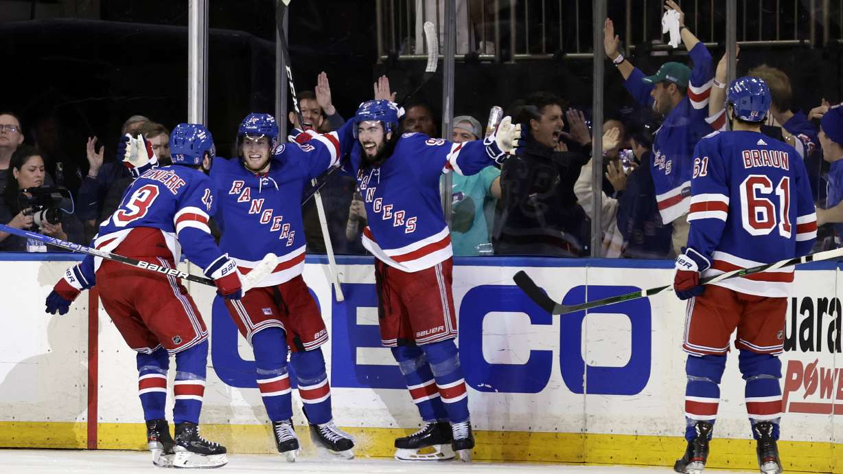 New York Rangers center Mika Zibanejad (93) celebrates with teammates after scoring a goal against the Pittsburgh Penguins during the third period in Game 7 of an NHL hockey Stanley Cup first-round playoff series Sunday, May 15, 2022, in New York.