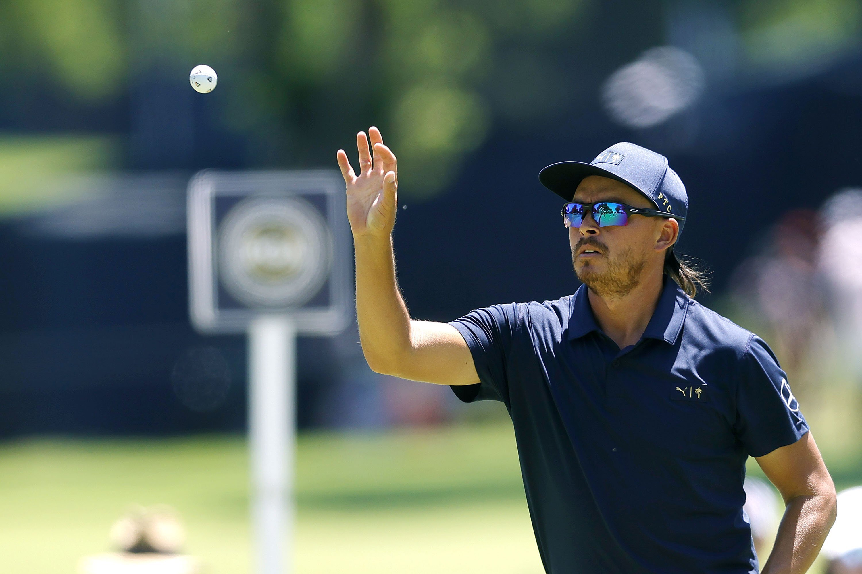Rickie Fowler catches a ball while working on putting on the 2nd hole during a practice round for the PGA Championship at Southern Hills Country Club, Monday, May 16, 2022, in Tulsa, Okla. 