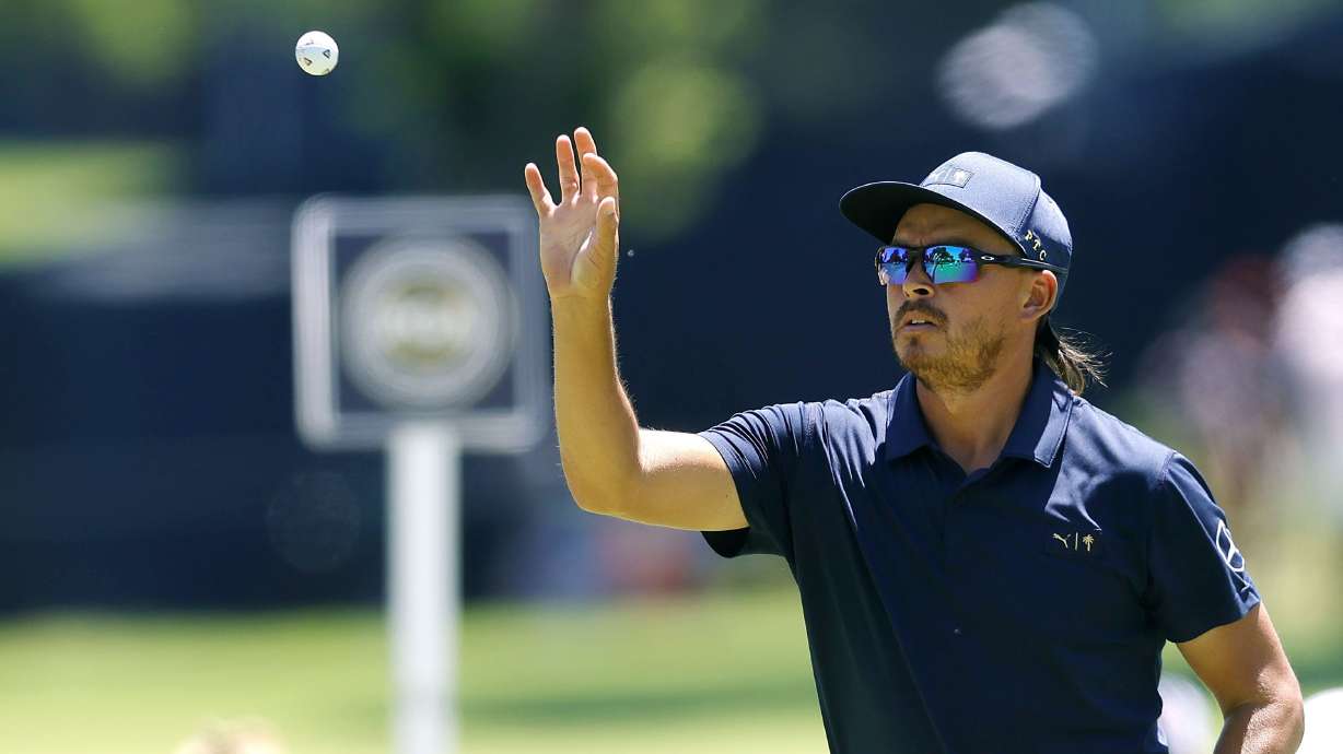 Rickie Fowler catches a ball while working on putting on the 2nd hole during a practice round for the PGA Championship at Southern Hills Country Club, Monday, May 16, 2022, in Tulsa, Okla.