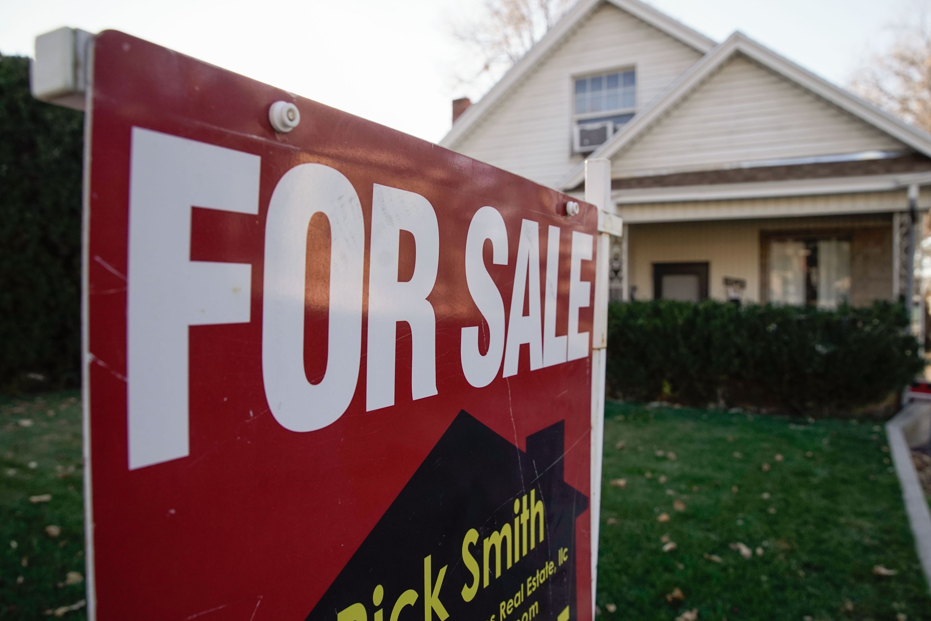 A “for sale” sign is displayed outside of a house in the Sugar House neighborhood of Salt Lake City on Dec. 7, 2021.