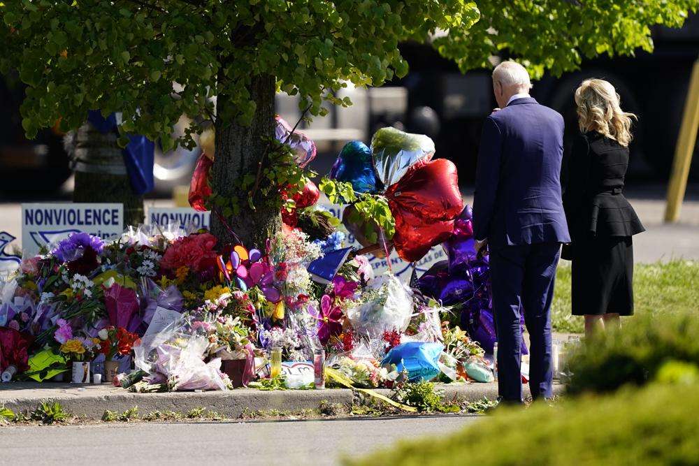 President Joe Biden and first lady Jill Biden visit the scene of a shooting at a supermarket to pay respects and speak to families of the victims of Saturday's shooting in Buffalo, N.Y., Tuesday. Biden on Tuesday condemned the poison of white supremacy and said the nation must "reject the lie" of the racist "replacement theory" espoused by the shooter who killed 10 Black people in Buffalo.