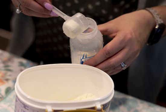 Cyndle Bass prepares a bottle of formula at her Eagle Mountain home on May 11. A 19.5-ounce can of formula lasts just one and half days for Bass. She feeds Austin and his twin sister, Alexis, 6 ounces every three hours. Sen. Mike Lee has a proposal to combat the national baby formula shortage, which he attributes to the Biden administration.