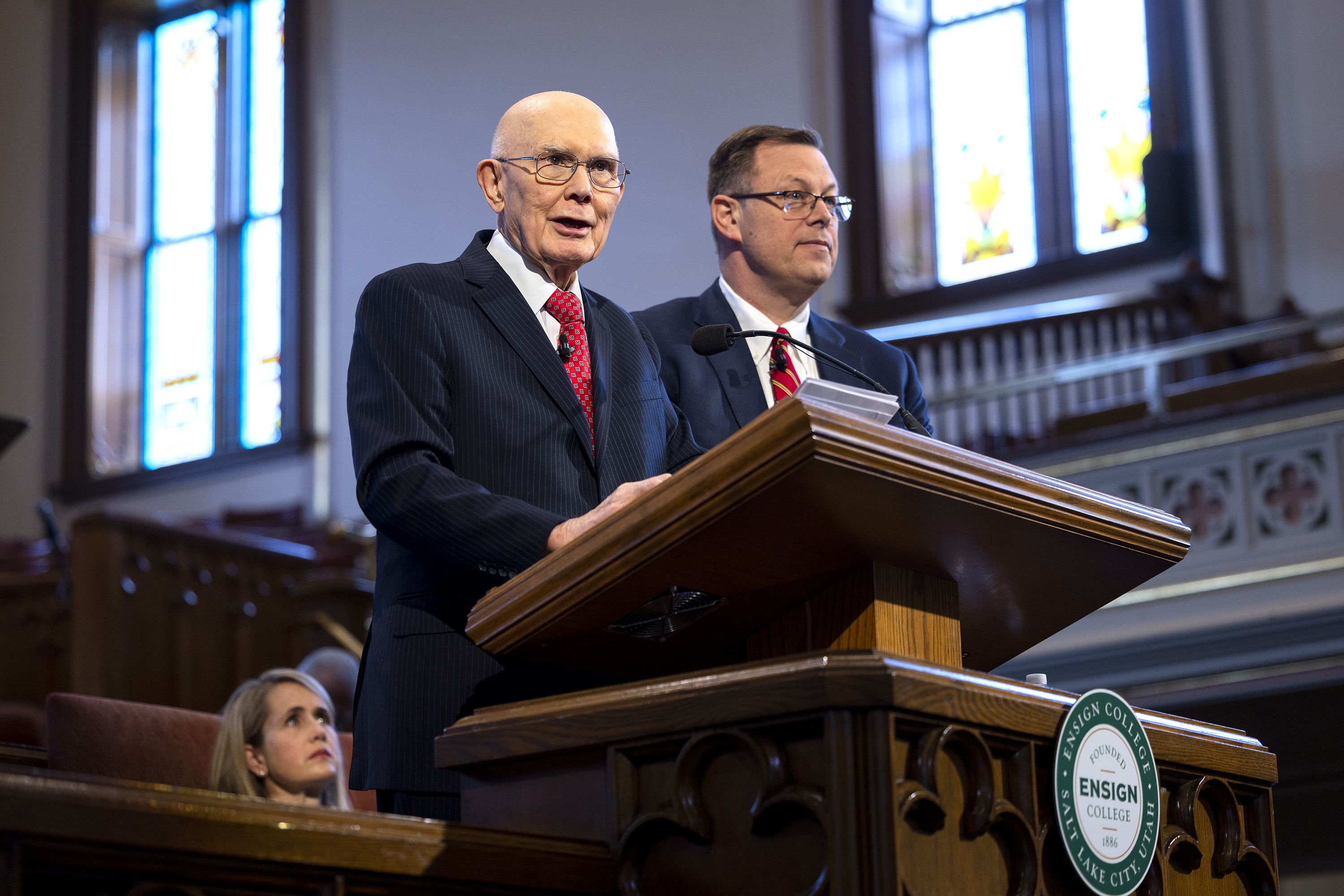 President Dallin H. Oaks, first counselor in the First Presidency of The Church of Jesus Christ of Latter-day Saints, left, and Elder Clark G. Gilbert, a General Authority Seventy and church commissioner of education, speak at an Ensign College devotional in the Assembly Hall on Temple Square in Salt Lake City on Tuesday.