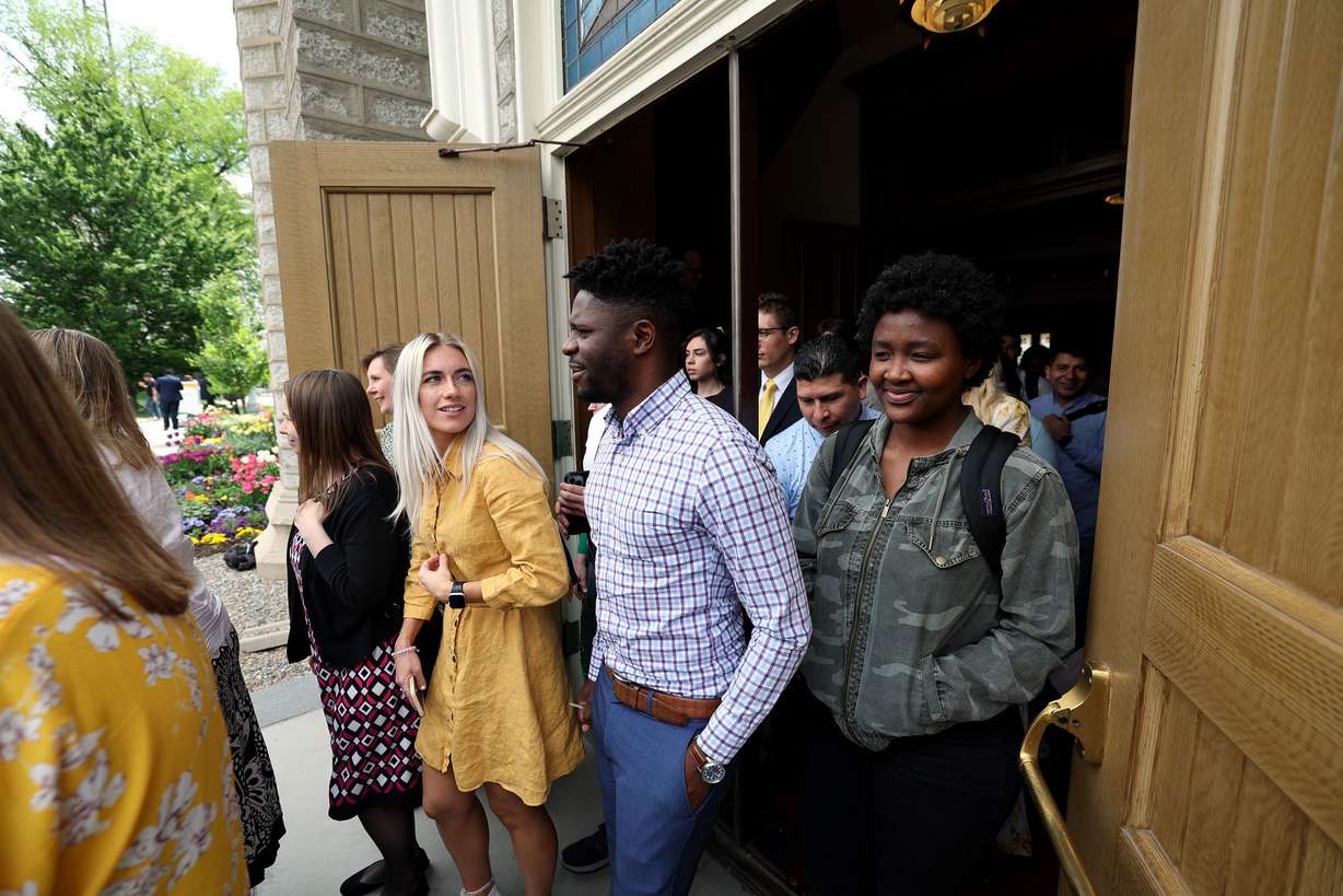 Audience members leave the Assembly Hall on Temple Square in Salt Lake City on Tuesday after listening to President Dallin H. Oaks, first counselor in the First Presidency of The Church of Jesus Christ of Latter-day Saints, and Elder Clark G. Gilbert, a General Authority Seventy and church commissioner of education, speak at an Ensign College devotional.