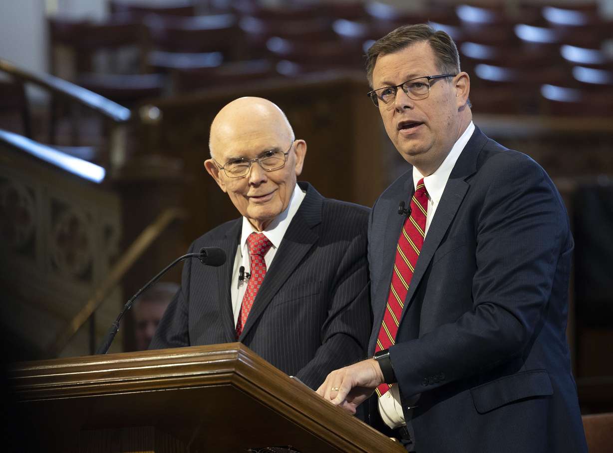 President Dallin H. Oaks, first counselor in the First Presidency of The Church of Jesus Christ of Latter-day Saints, left, and Elder Clark G. Gilbert, a General Authority Seventy and church commissioner of education, speak at an Ensign College devotional in the Assembly Hall on Temple Square in Salt Lake City on Tuesday.