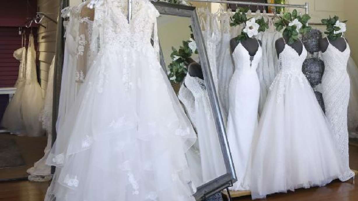 FILE - Wedding dresses are displayed at a bridal shop in East Dundee, Ill., on Feb. 28, 2020. Far fewer Americans were married during the first year of the COVID-19 pandemic, with the number of U.S. marriages in 2020 being the lowest recorded since 1963, according to statistics released by the Centers for Disease Control and Prevention on Tuesday, May 17, 2022. (AP Photo/Teresa Crawford, File)