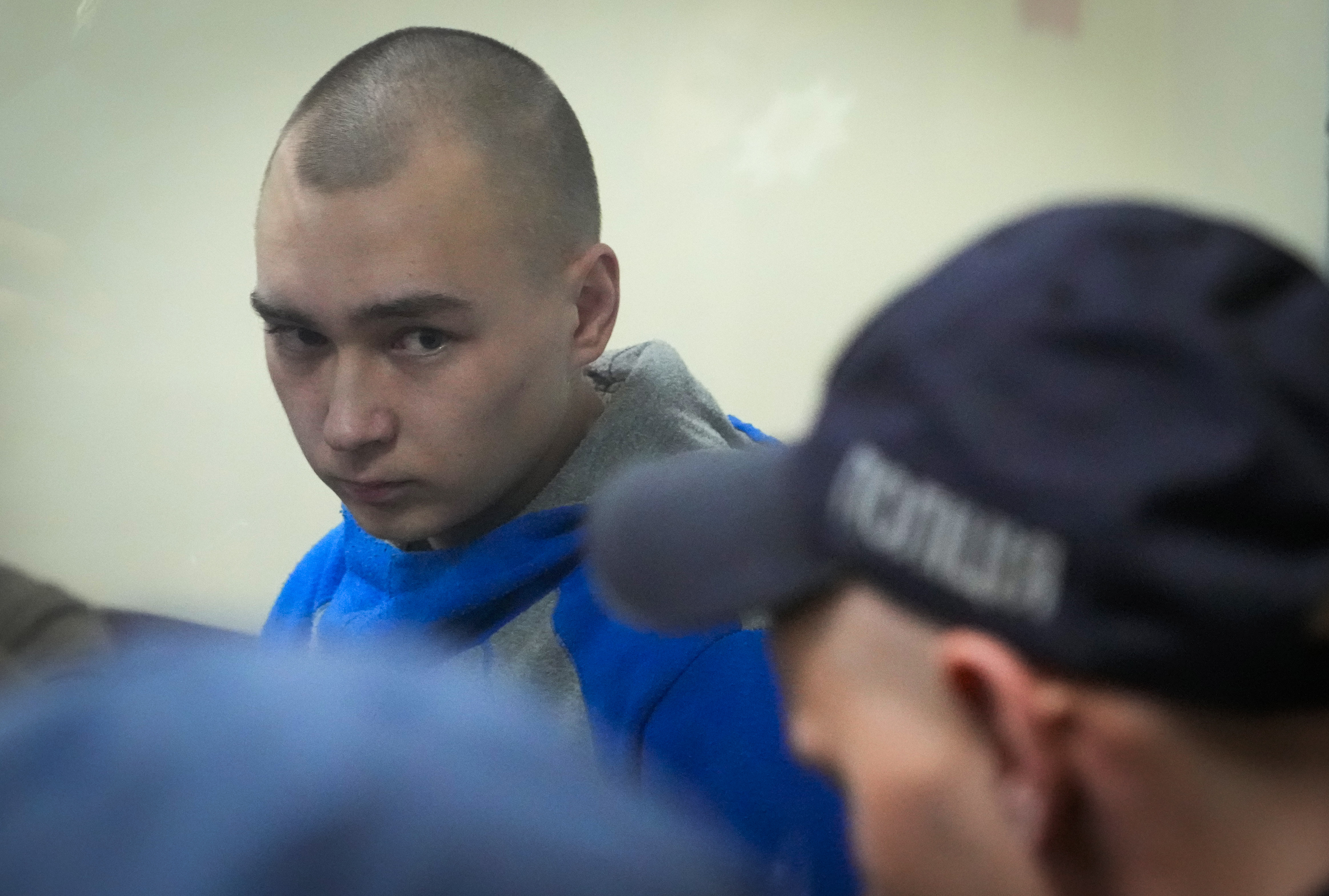 Russian army Sergeant Vadim Shishimarin, 21, is seen behind a glass during a court hearing in Kyiv, Ukraine, Wednesday. The Russian soldier has pleaded guilty to killing an unarmed civilian.