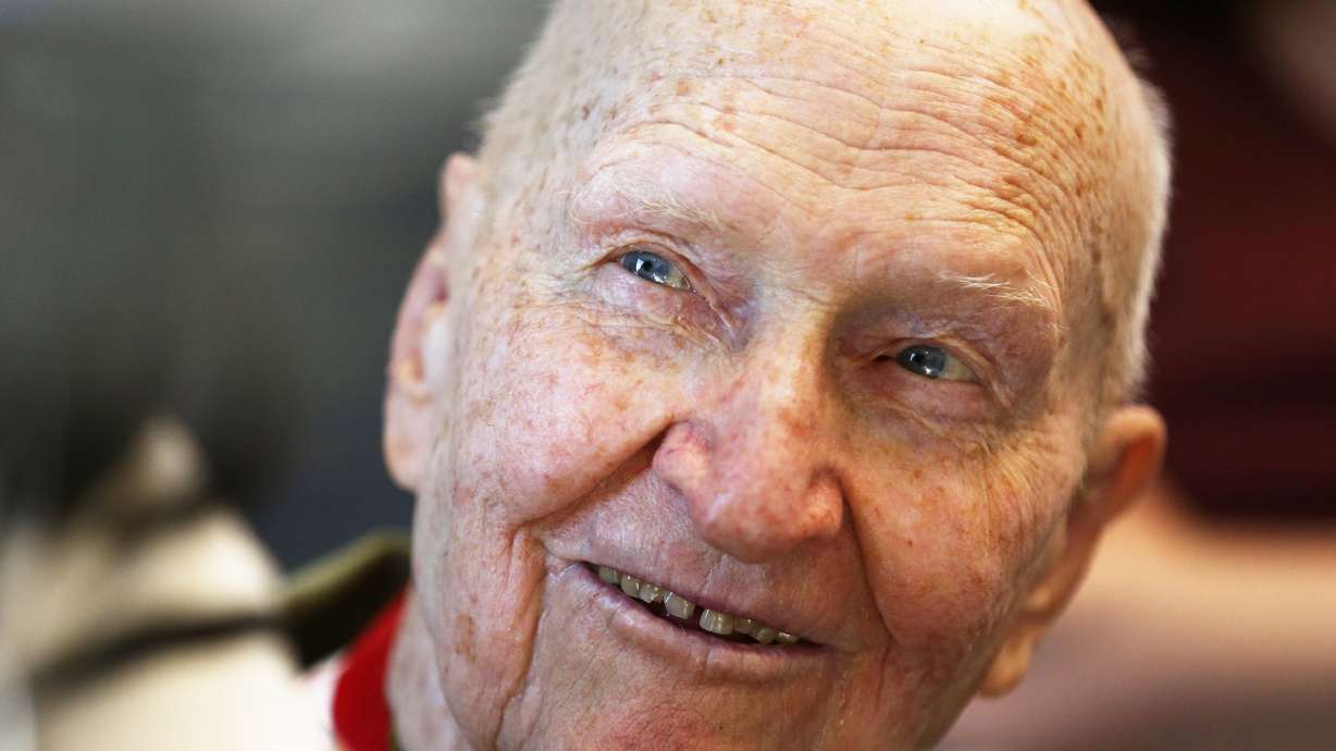 The “Candy Bomber” Gail Halvorsen joins members of Follow the Flag at Colonial Flag in Sandy for a photo as work goes on to construct a giant flag on May 12, 2017. The Provo Veterans Center will soon be renamed to honor of Halvorsen, who died in February at the age 101.