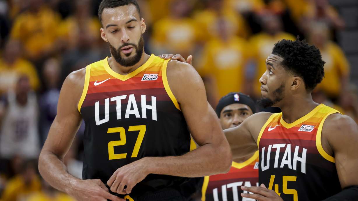 Utah Jazz guard Donovan Mitchell (45) cheers Utah Jazz center Rudy Gobert (27) up after a play at Game 3 of an NBA basketball first-round playoff series at Vivint Arena in Salt Lake City on Thursday, April 21, 2022.