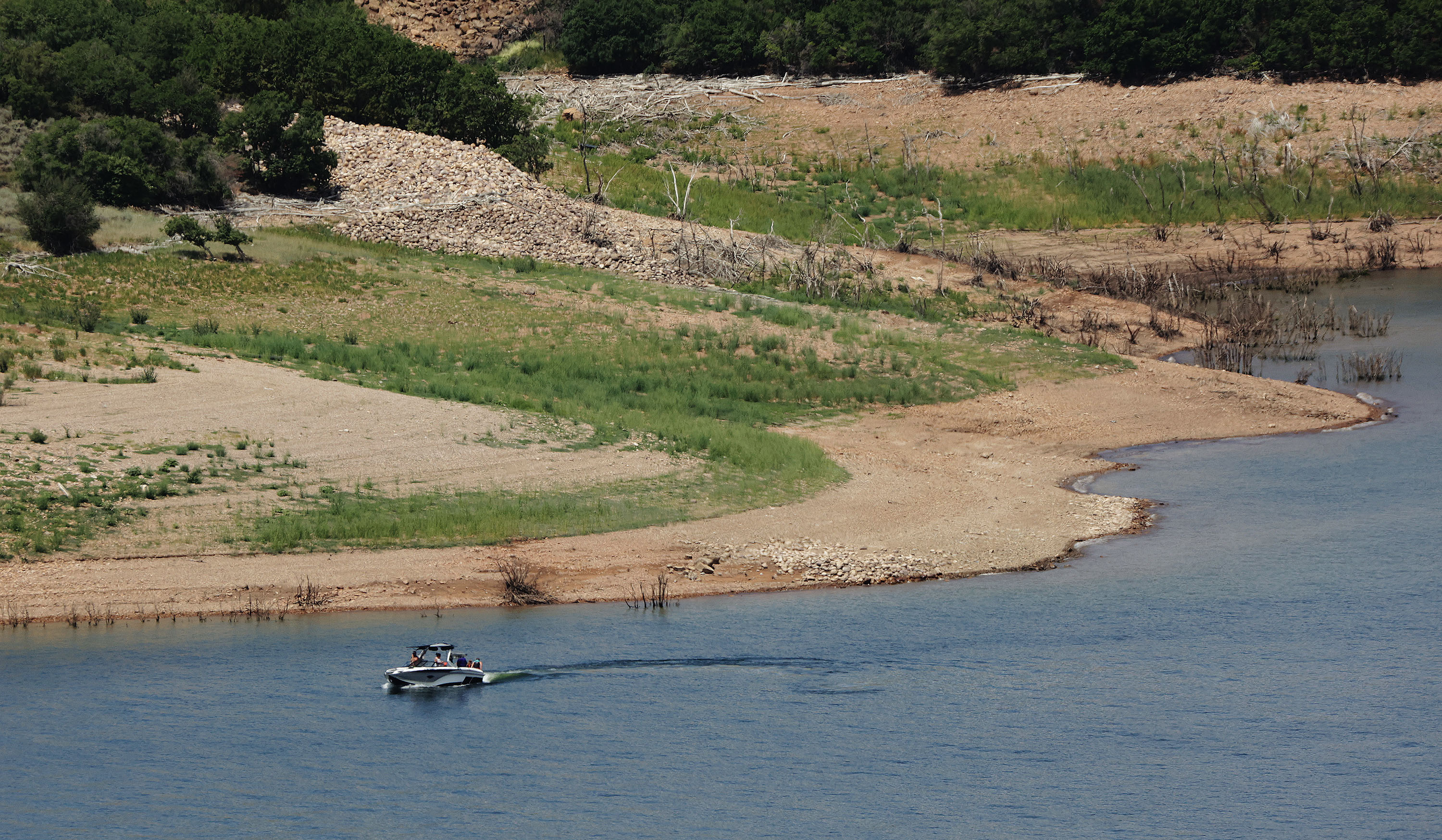 A boater enjoys the water at Jordanelle State Park on July 16, 2021. The water levels are low due to drought. A recent study breaks down drought data from the past 20 years.