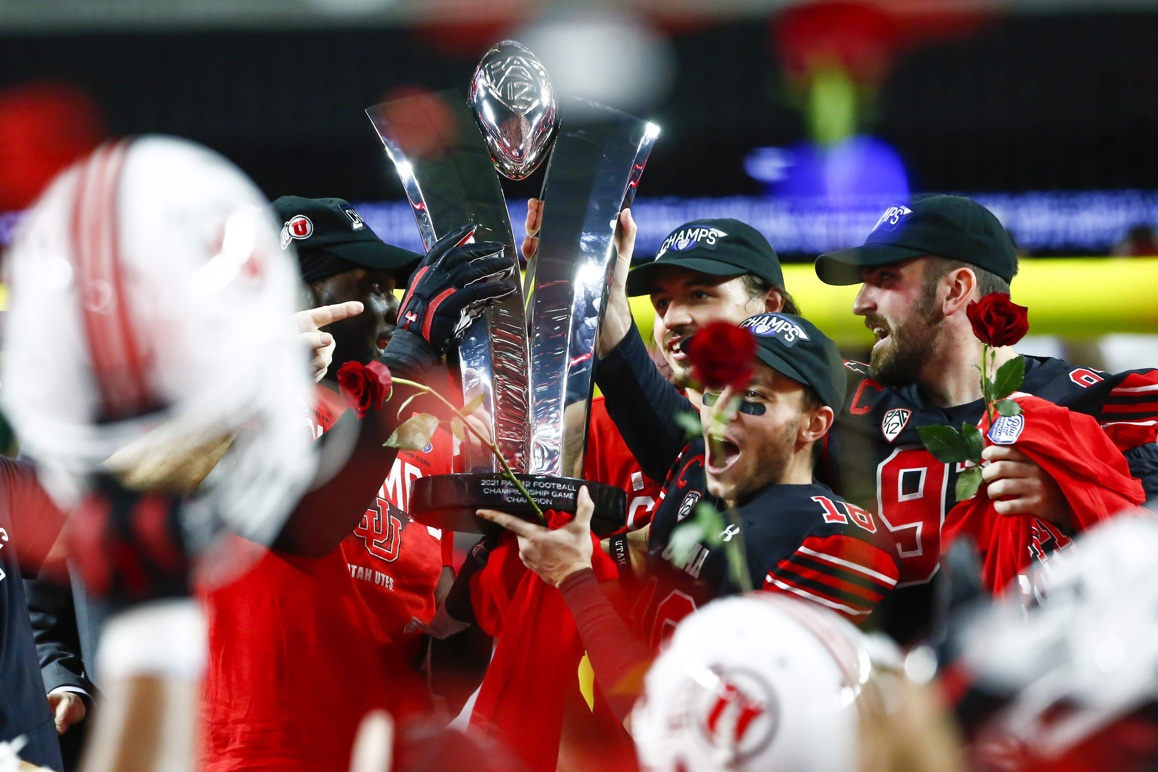 FILE - Utah players celebrate with the trophy after their victory over Oregon to win the Pac-12 Conference championship NCAA football game Friday, Dec. 3, 2021, in Las Vegas. The Pac-12 announced, Wednesday, May 18, 2022, it was scrapping its divisional format for the coming season Wednesday, May 18, 2022. 