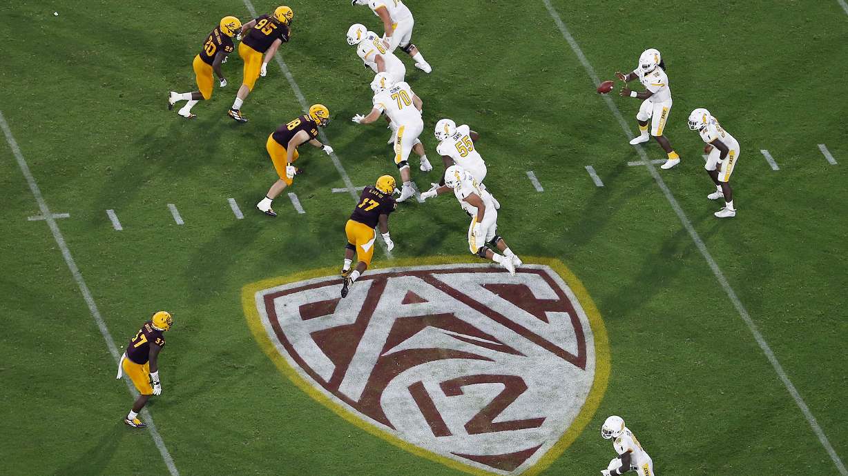 The Pac-12 logo is shown during the second half of an NCAA college football game between Arizona State and Kent State, in Tempe, Ariz. on Aug. 29, 2019. The Pac-12 announced, Wednesday, May 18, 2022, it was scrapping its divisional format for the coming season Wednesday, May 18, 2022.