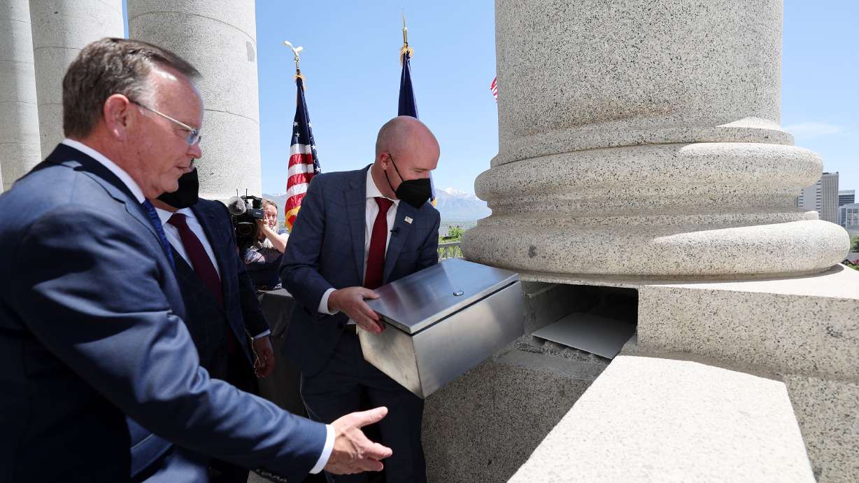 Gov. Spencer Cox, joined by House Speaker Brad Wilson, R-Kaysville, Senate President Stuart Adams, R-Layton, Utah Attorney General Sean D. Reyes and Chief Justice Matthew B. Durrant, places a time capsule into one of the columns at the state Capitol in Salt Lake City on Wednesday.