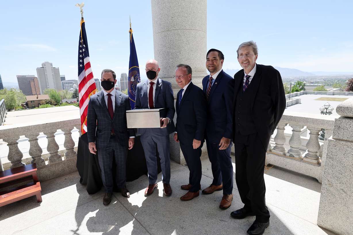 Gov. Spencer Cox poses with House Speaker Brad Wilson, R-Kaysville, Senate President Stuart Adams, R-Layton, Utah Attorney General Sean D. Reyes and Chief Justice Matthew B. Durrant at the Capitol in Salt Lake City prior to placing a new 100-year time capsule into a column on Wednesday, May 18, 2022.