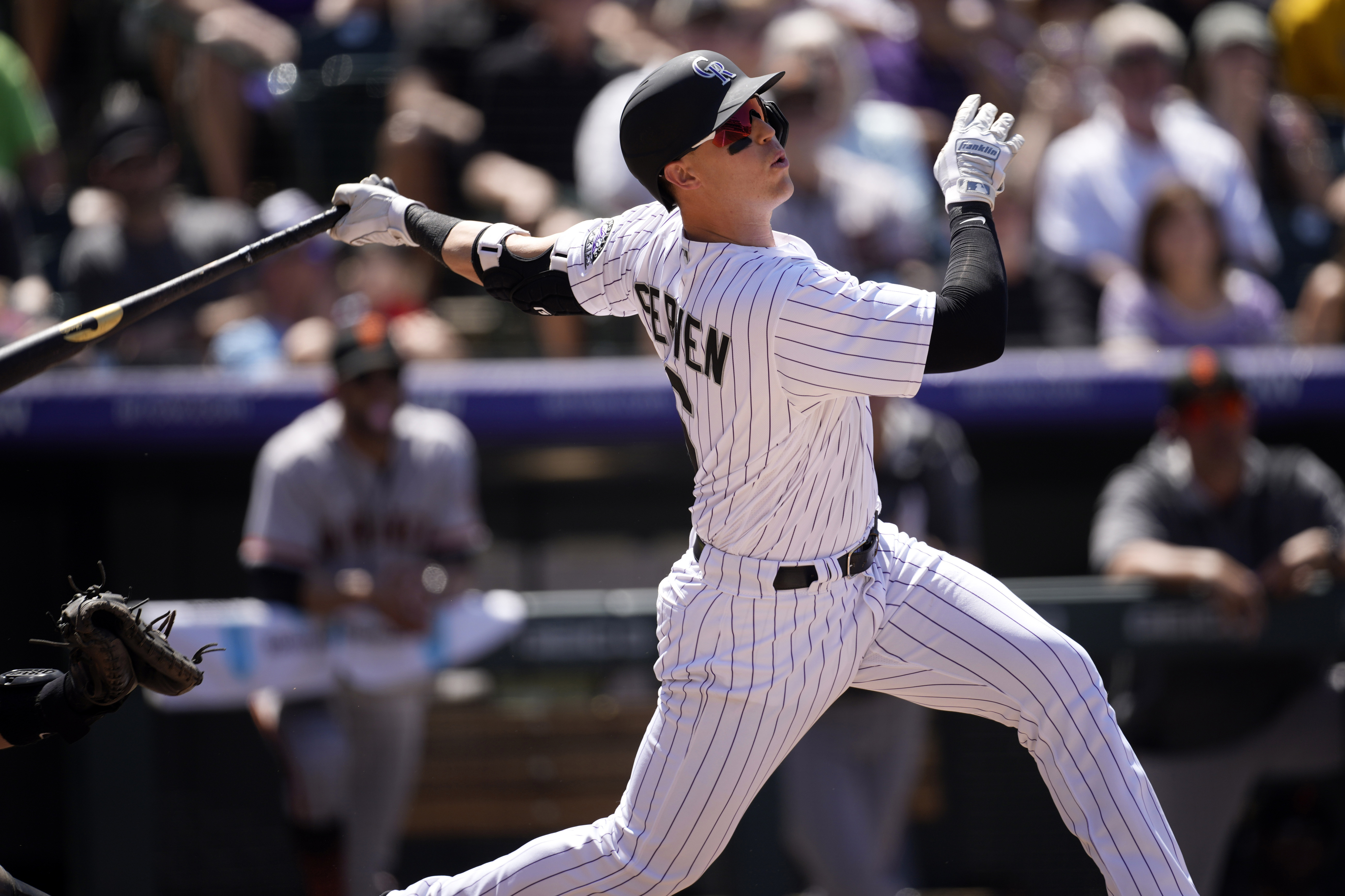 Colorado Rockies' Brian Sevren flies out against San Francisco Giants starting pitcher Logan Webb in the fifth inning of a baseball game Wednesday, May 18, 2022, in Denver. 